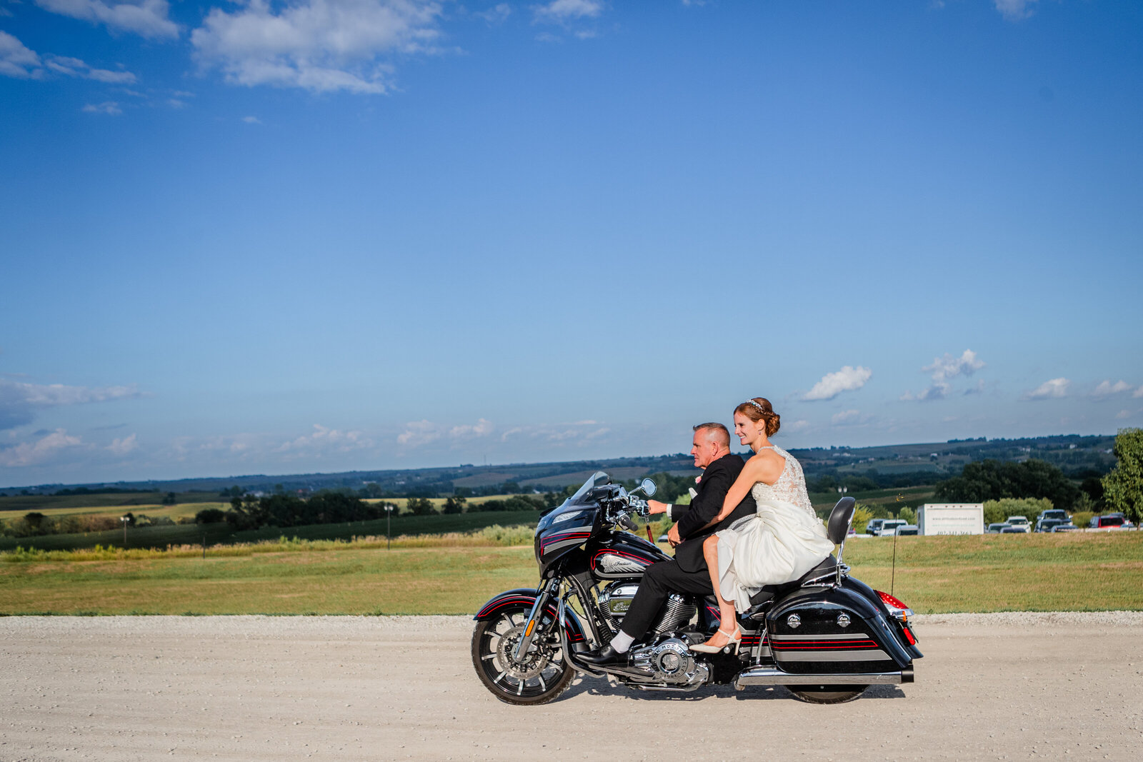 Bride and Groom on motorcycle with blue sky