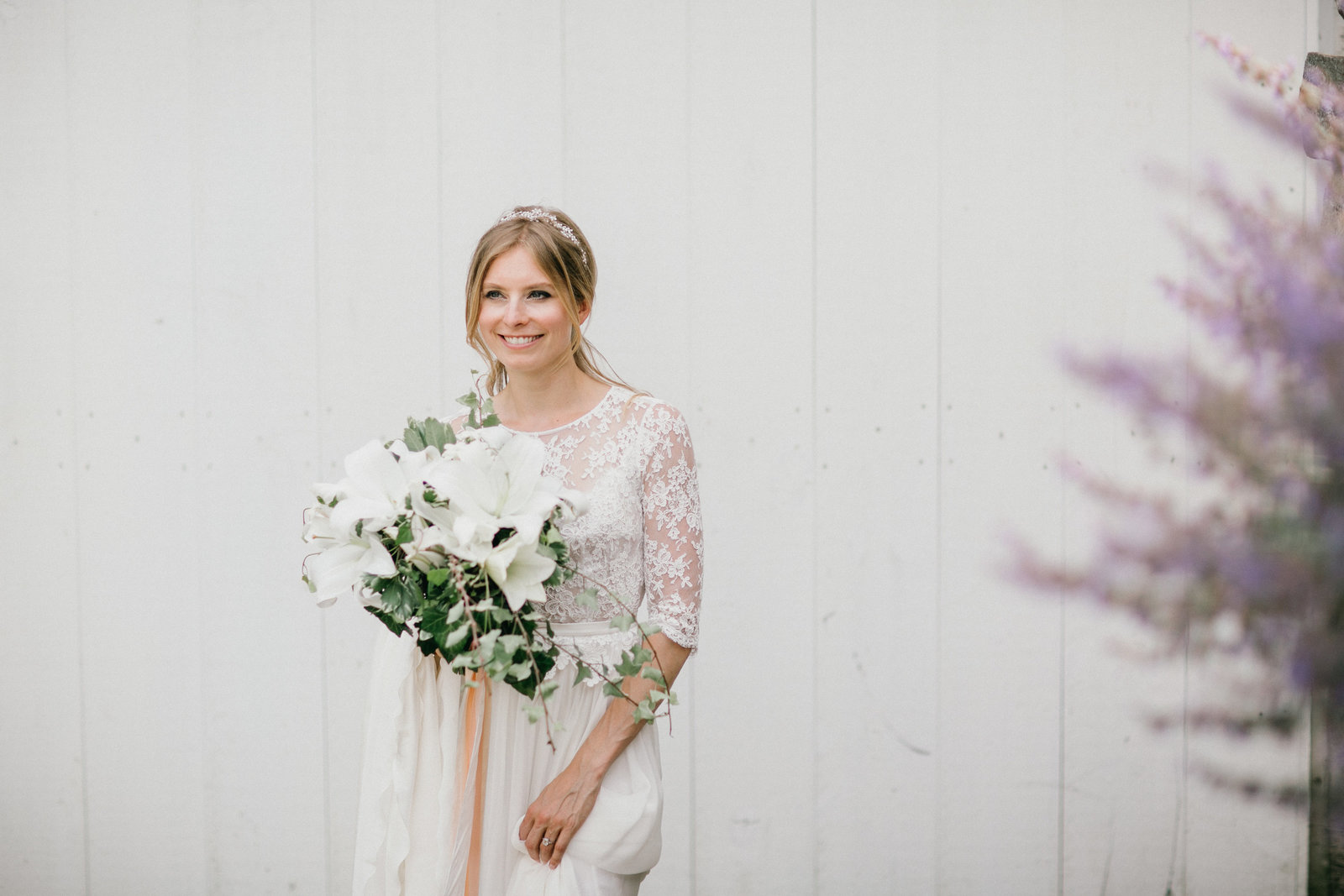 Beautiful bride photographed with her gorgeous white lily bouquet from Wild Stems.