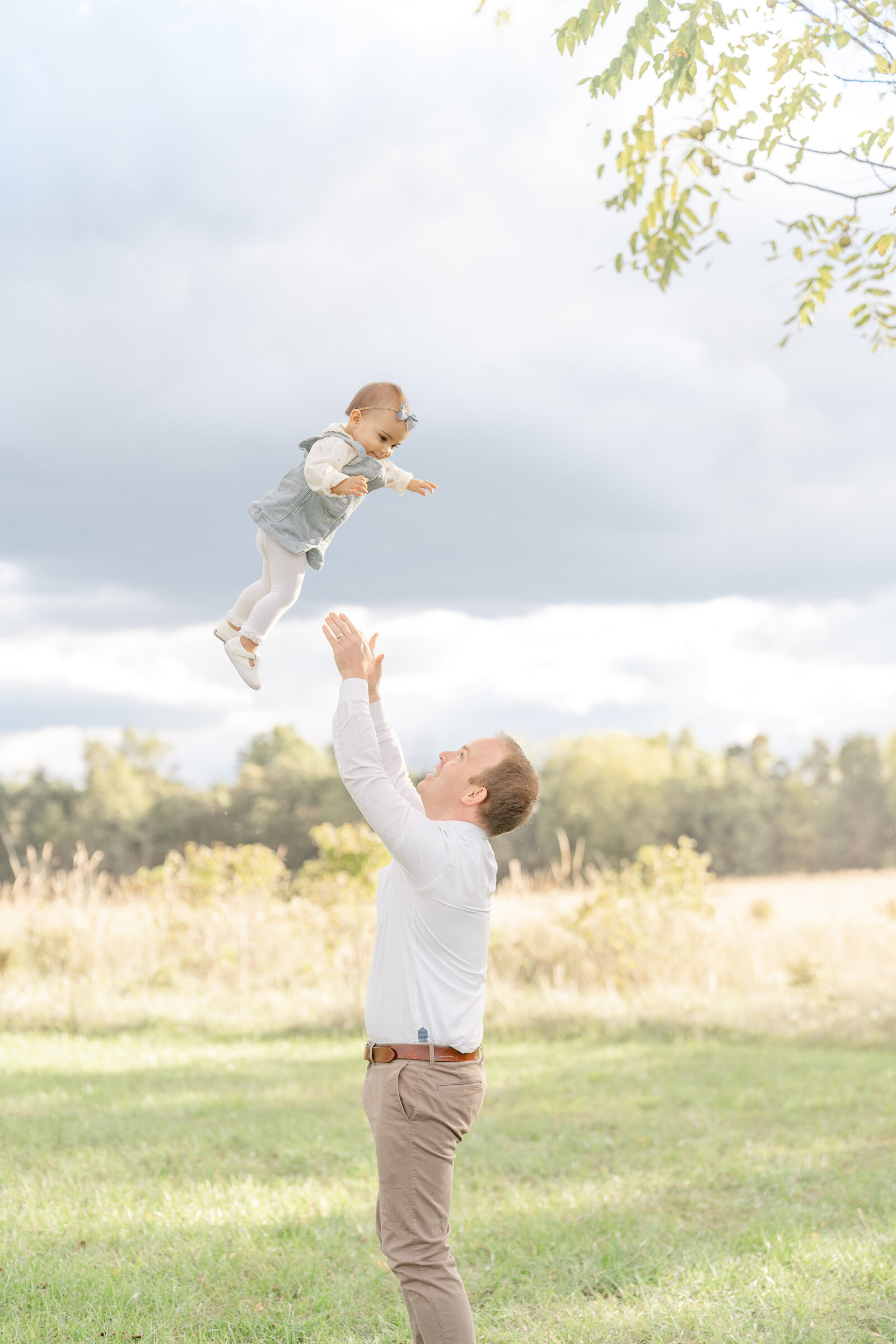 dad playing with baby during Sterling, Virginia family photography