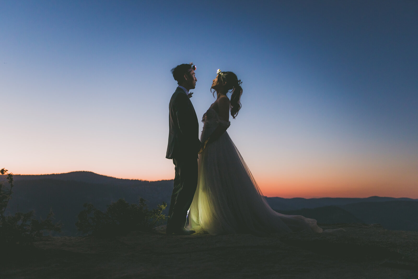 A couple puts on their headlamps for their Yosemite sunset hiking elopement.