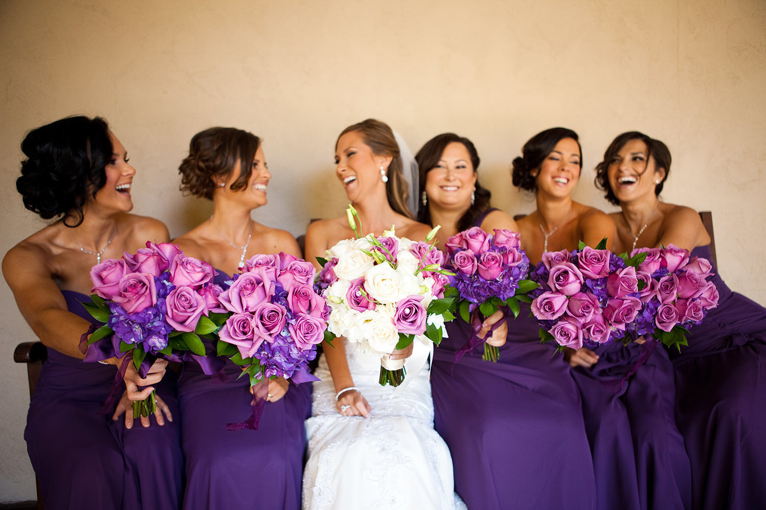 bridal party at balboa park prado wedding purple dresses