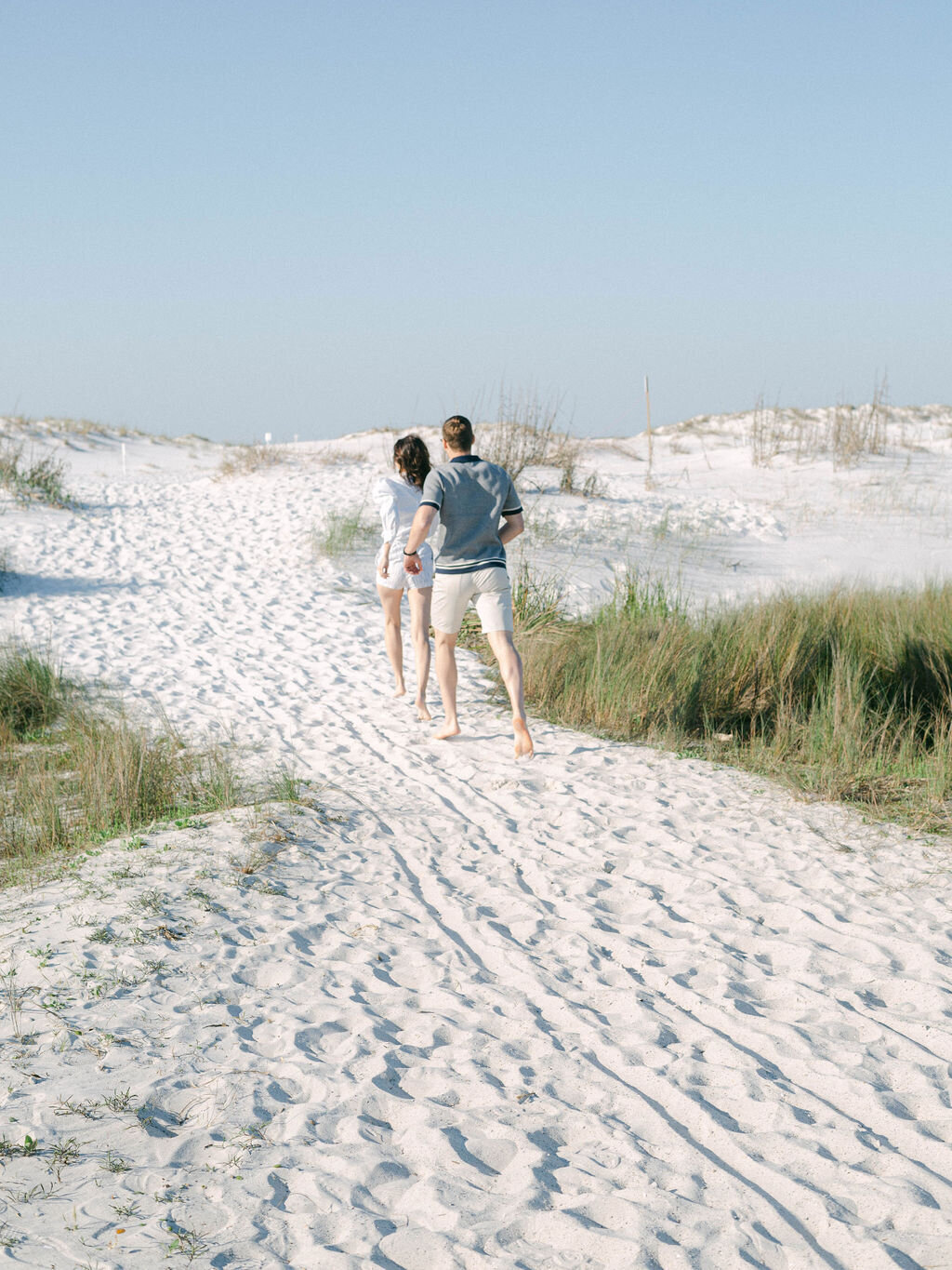 couple walking along beach at Kaiya Beach Resort in Seacrest Florida