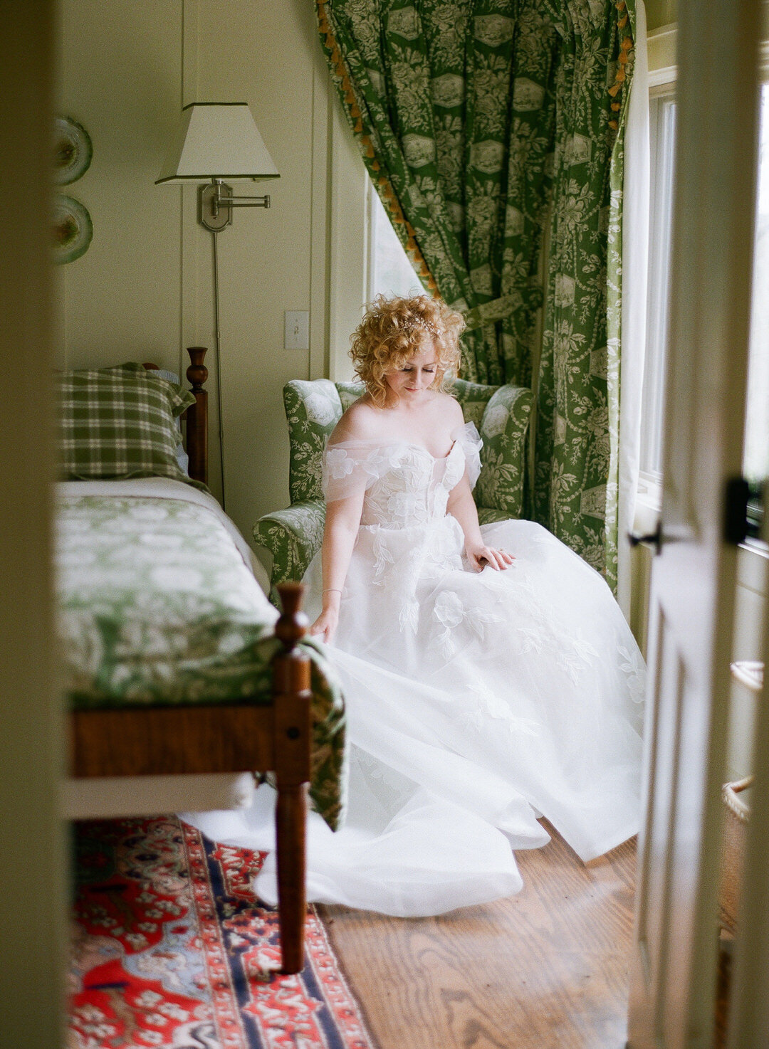 bride sitting on green chair in bedroom