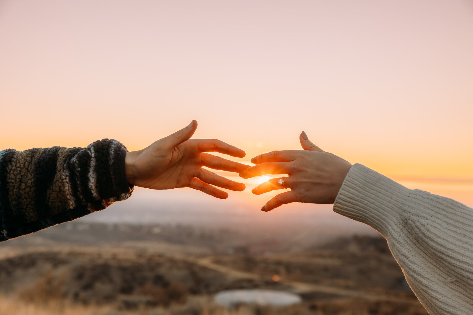 hands touching in sunset