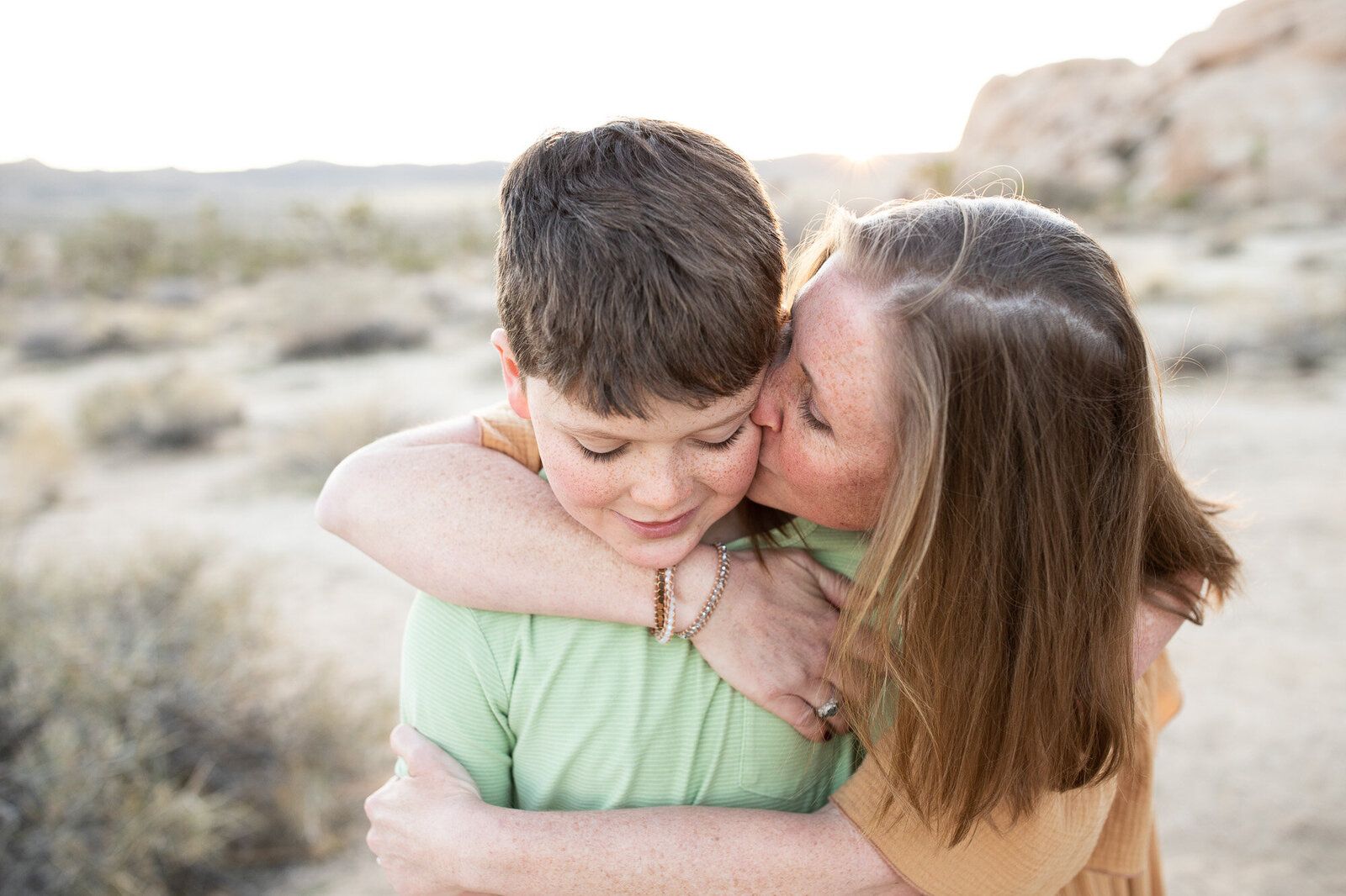 Mom and son hug at Joshua Tree National Park.