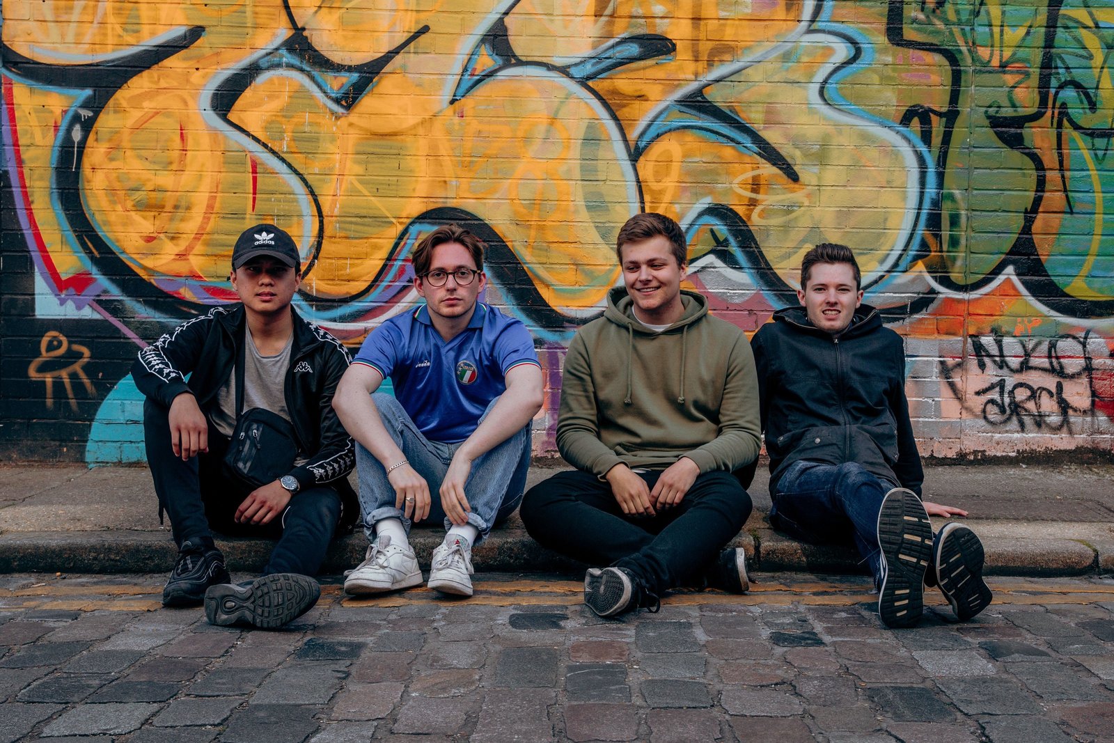 RAMES sat on a curb in Shoreditch during their press shoot