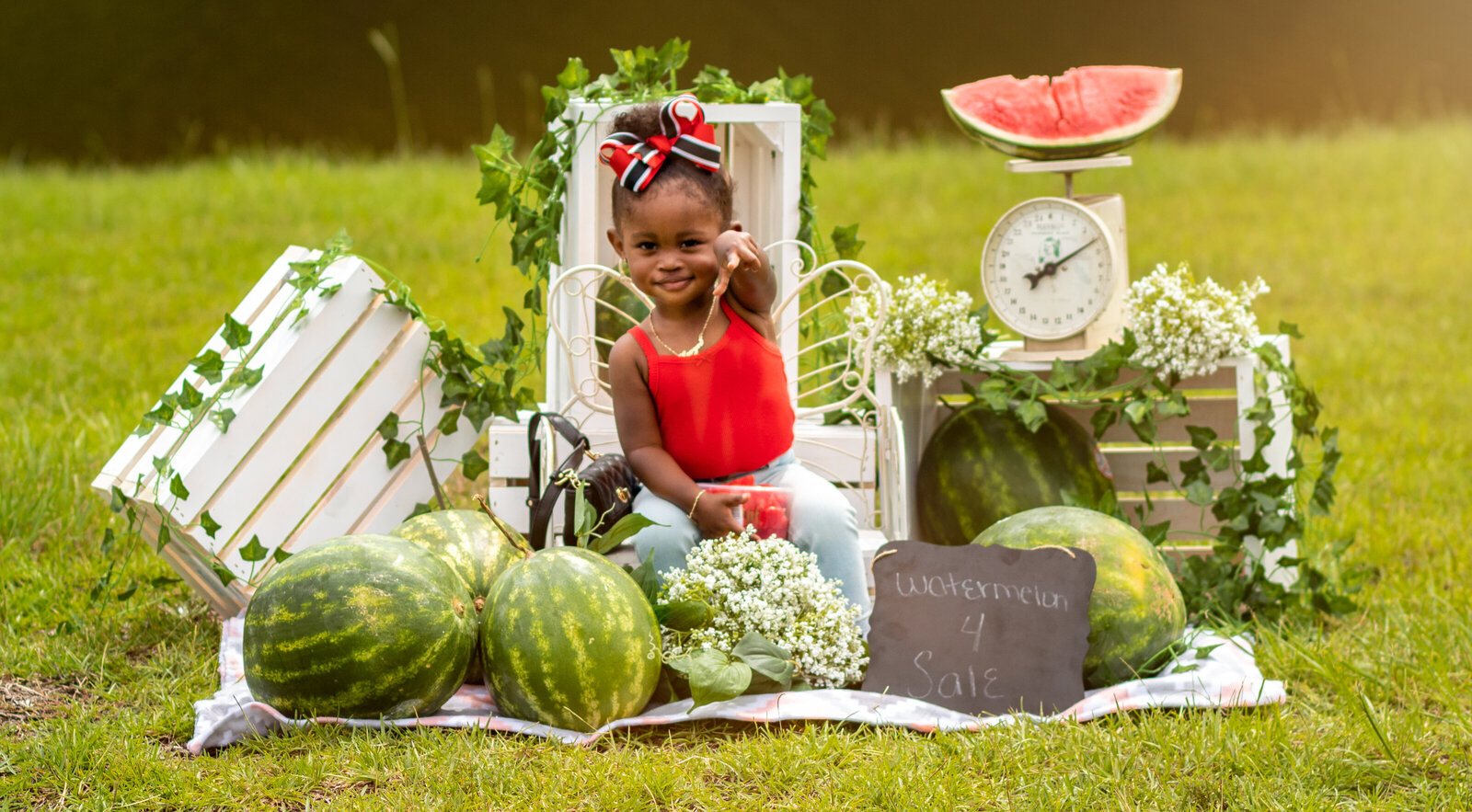 Watermelon session with little girl pointing