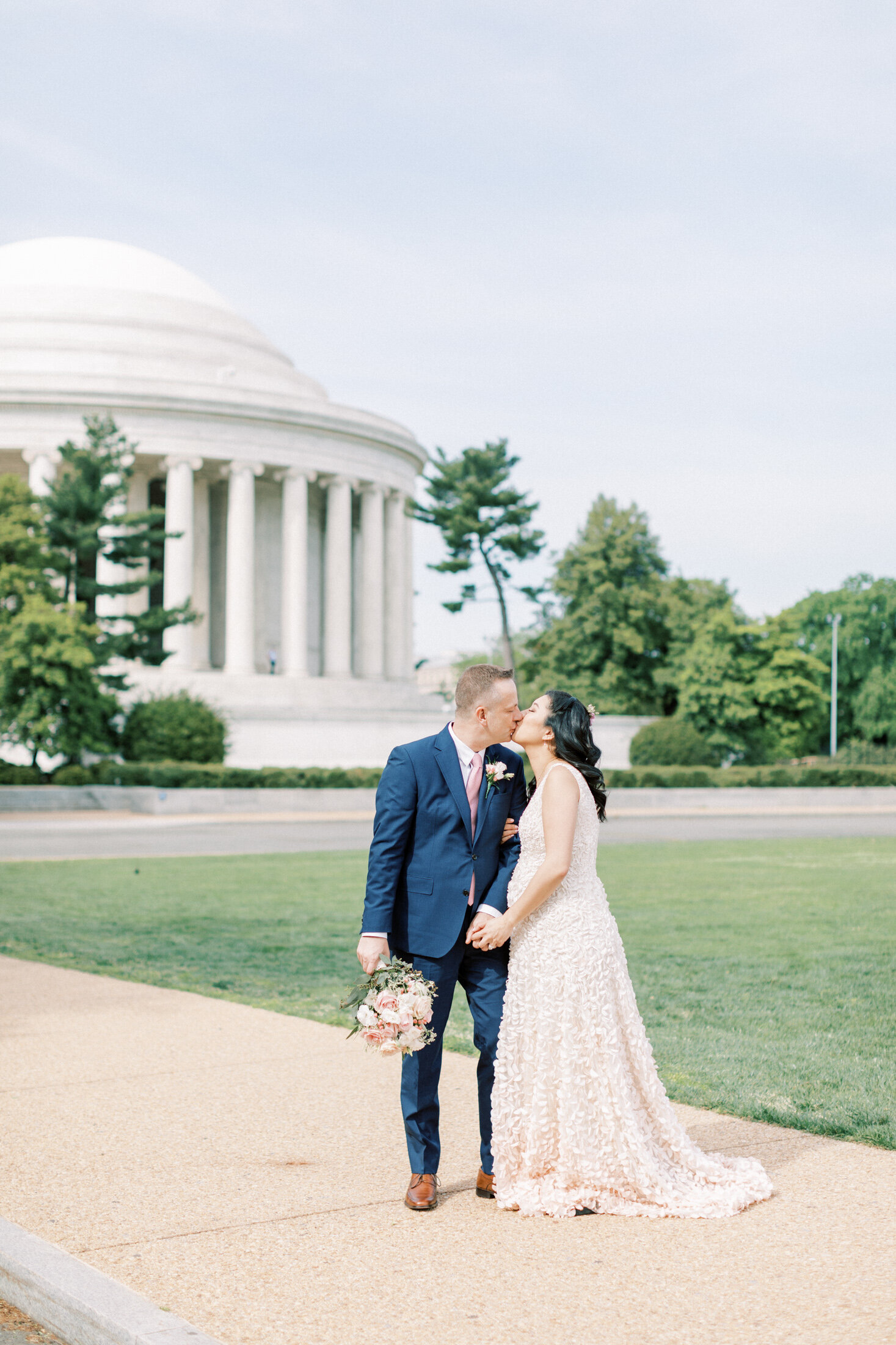 Bride and groom kiss in front of the Thomas Jefferson Monument