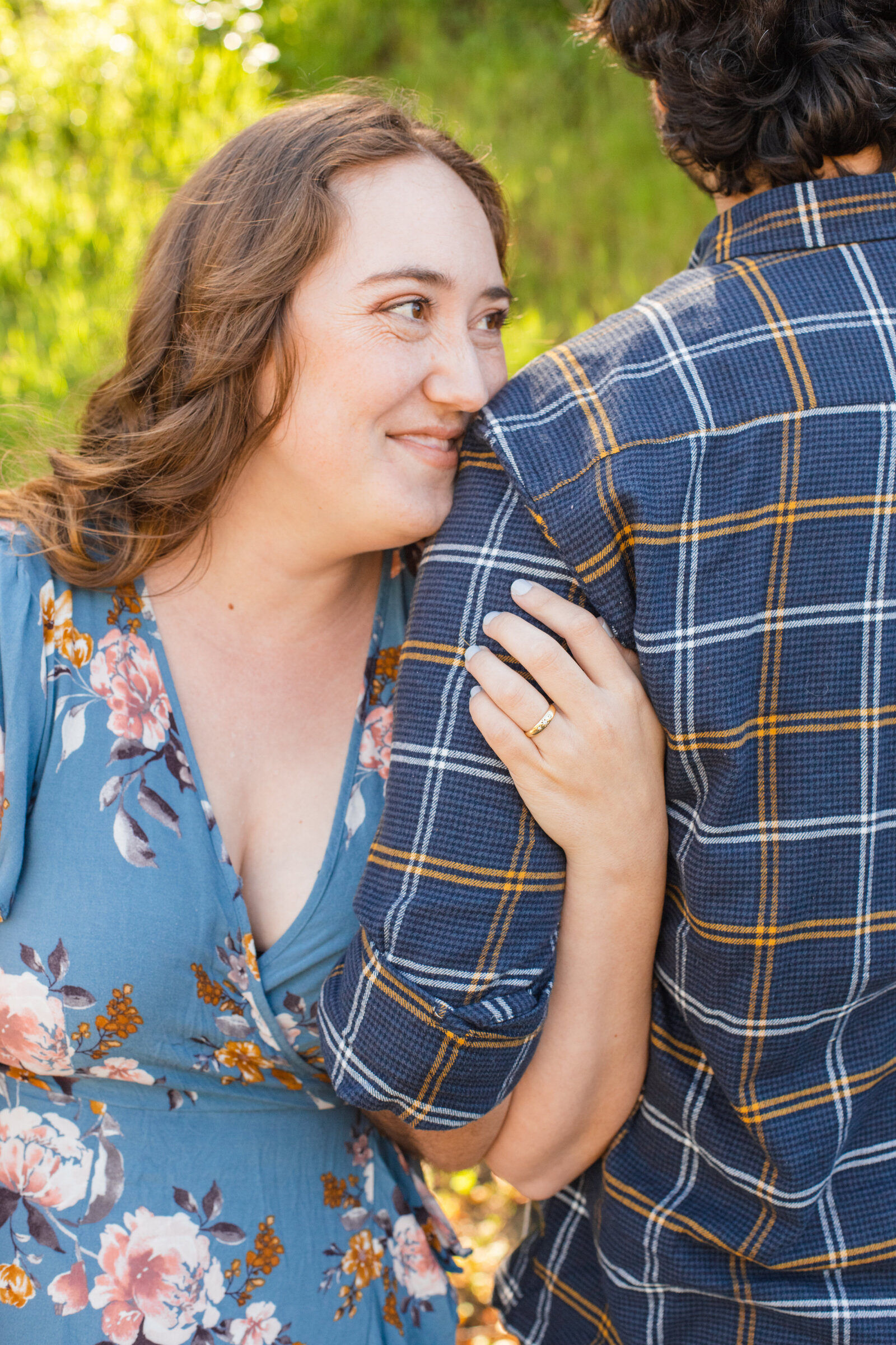 An engaged couple poses for photos in a garden in Los Angeles, Ca.