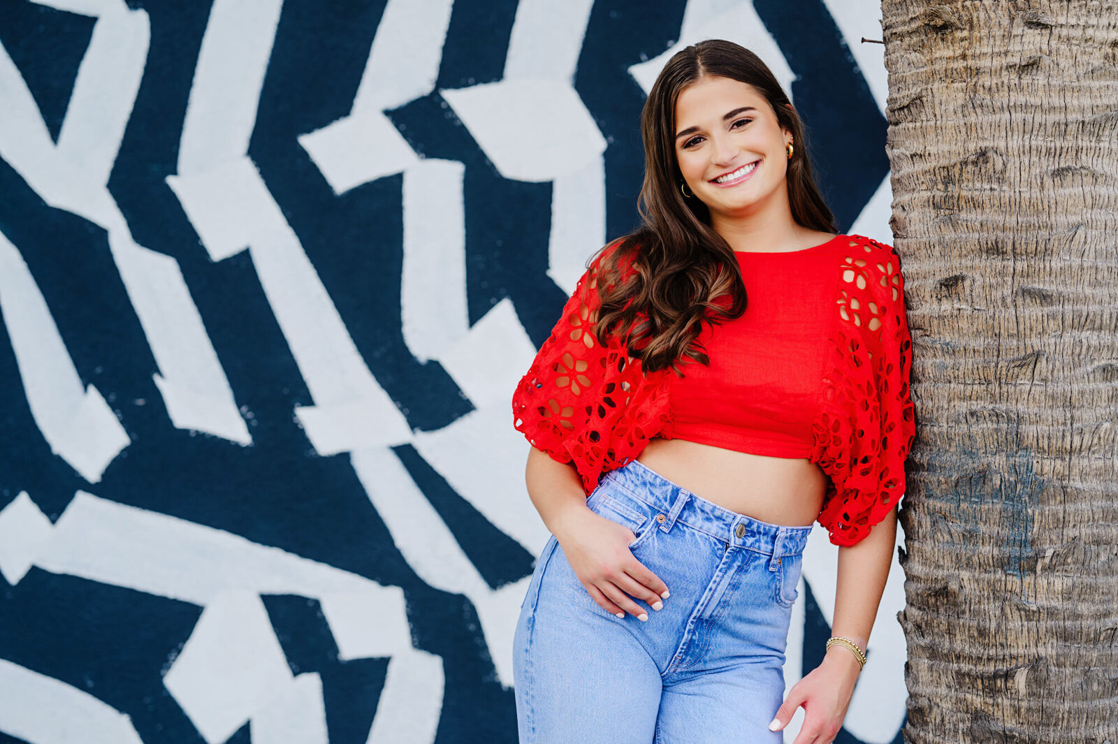 Jacksonville senior portrait at atalntic beach in a red shirt with urban wall