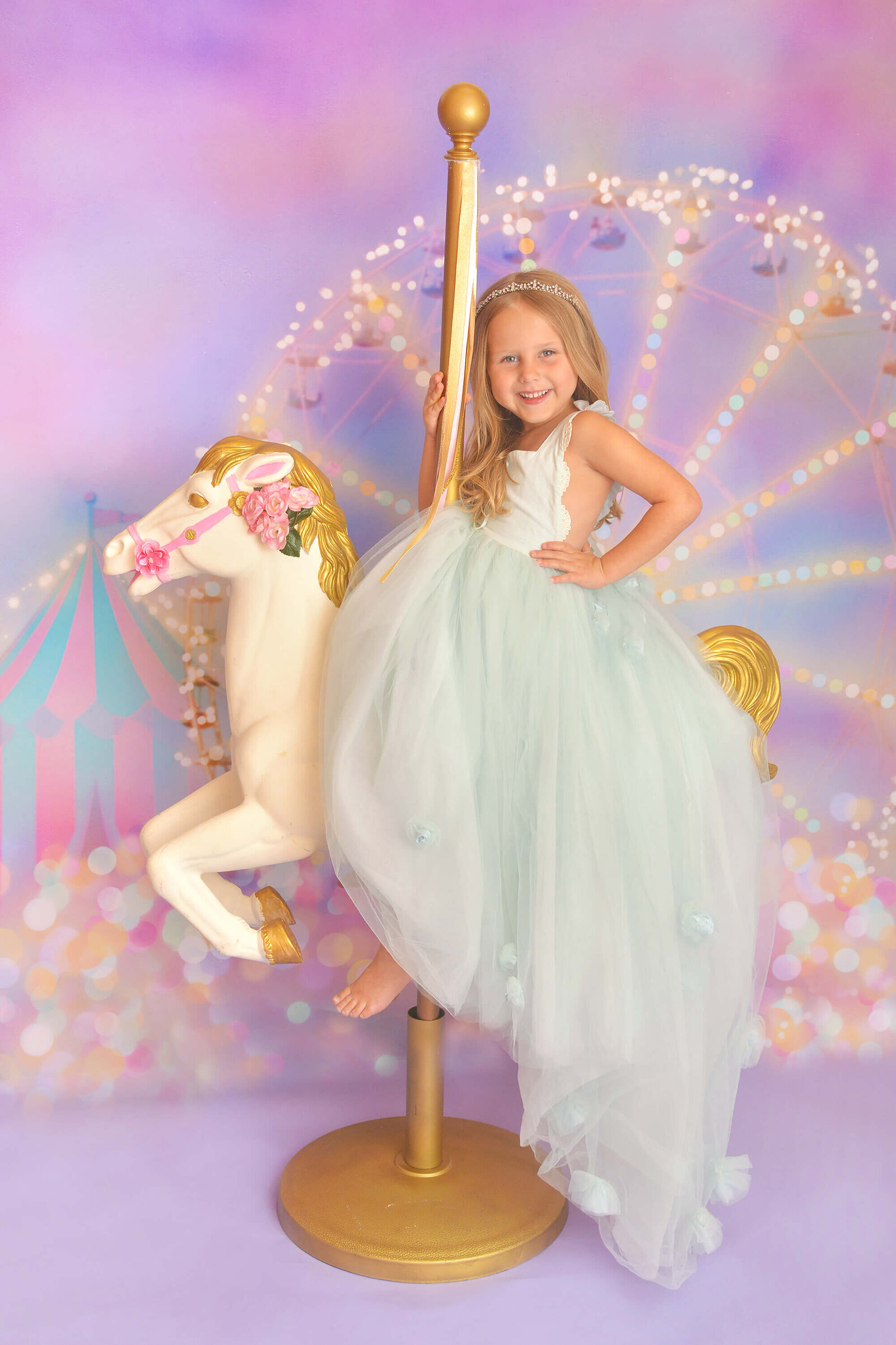 girl smiles while sitting on a carousel horse at her photoshoot in houston