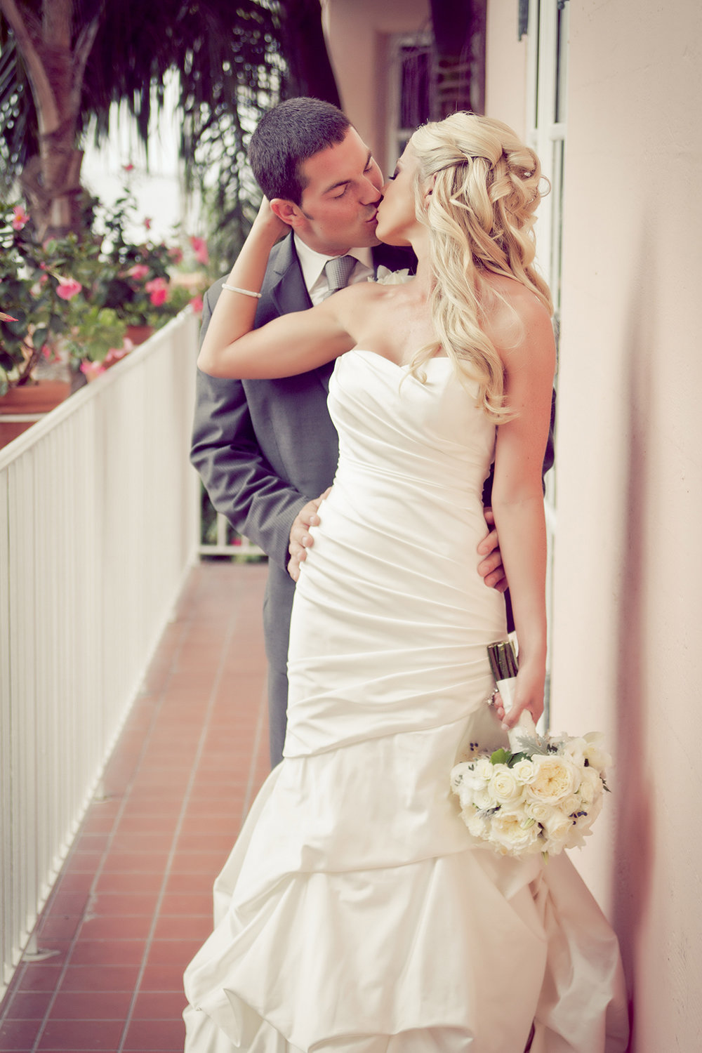 A sweet kiss between the bride and groom at La Valencia