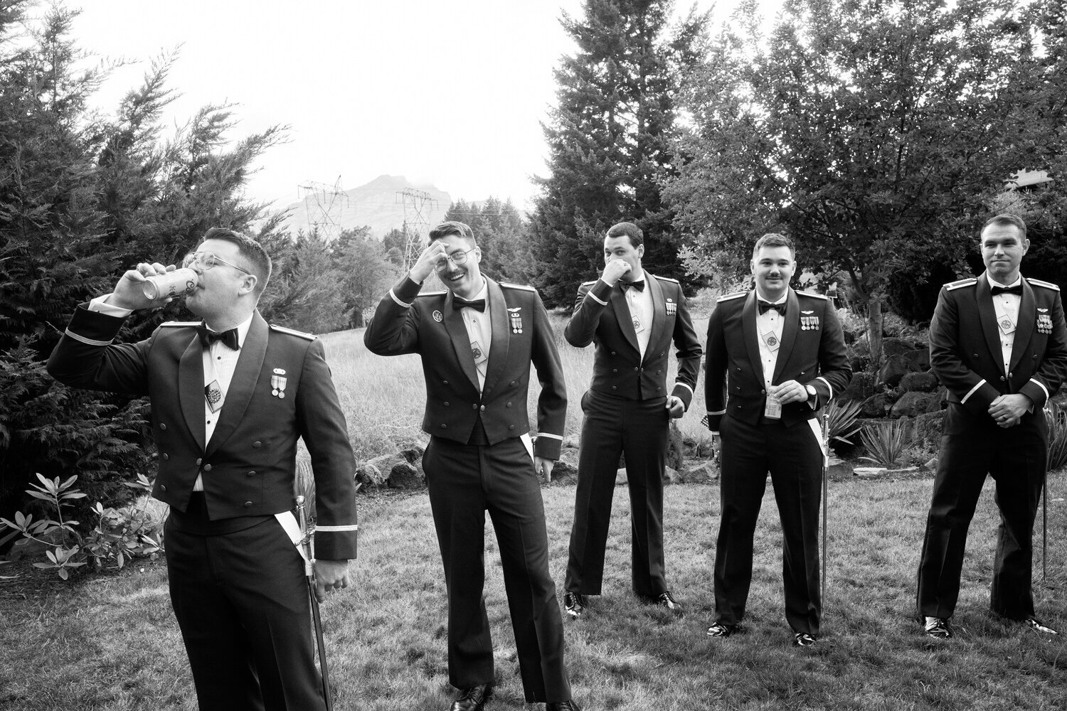 Groomsmen in military dress uniforms  wait for the portraits to conclude