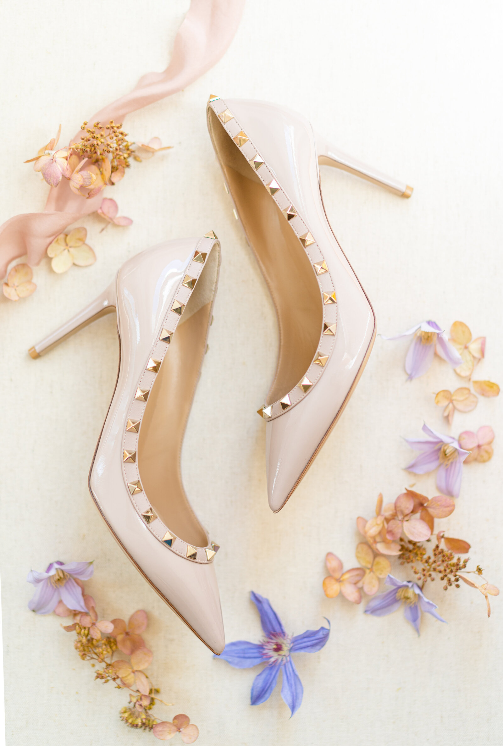 Cream heels set with lavender and peach-colored flowers.