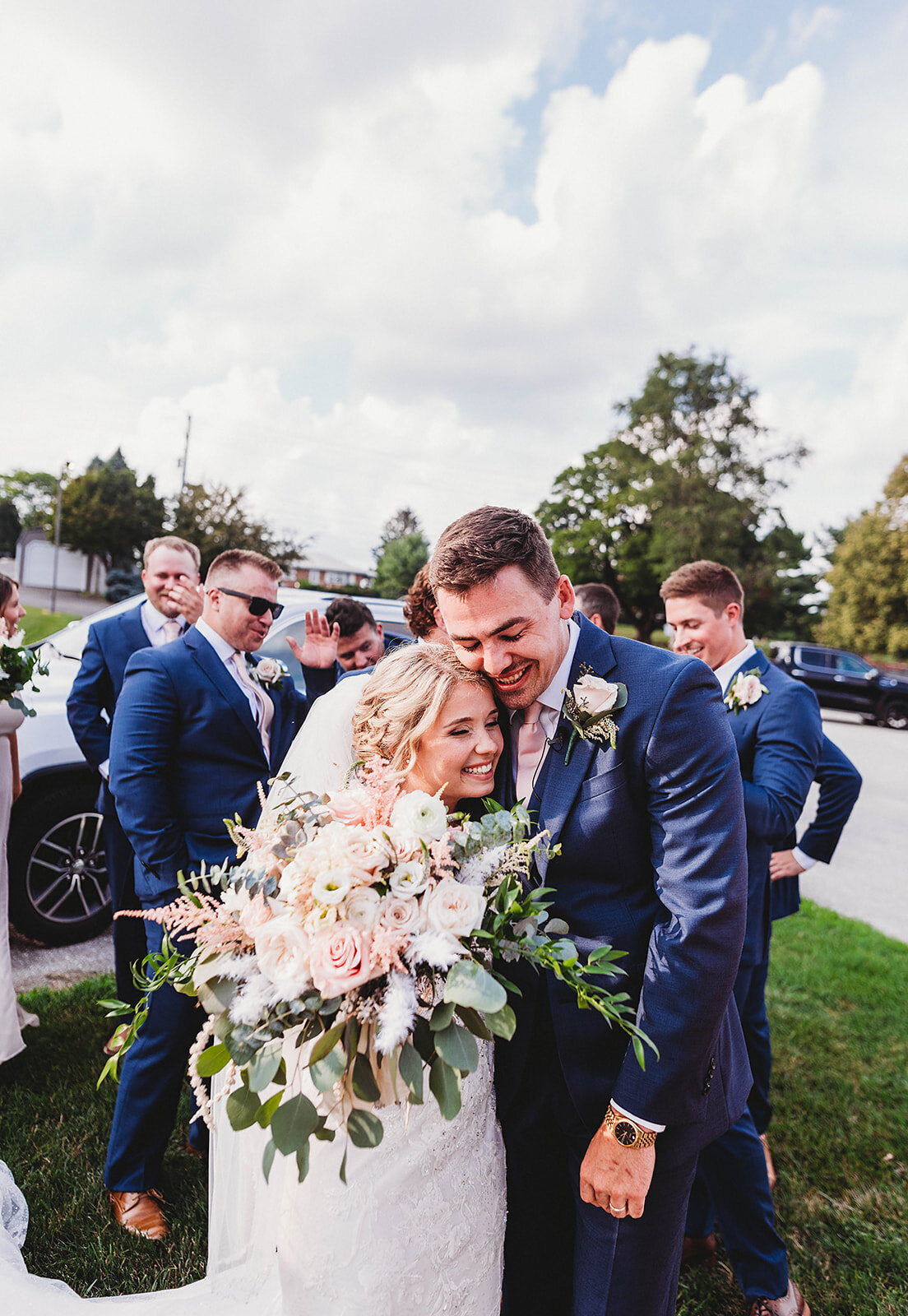 bride and groom share a initimate huge after their wedding ceremony