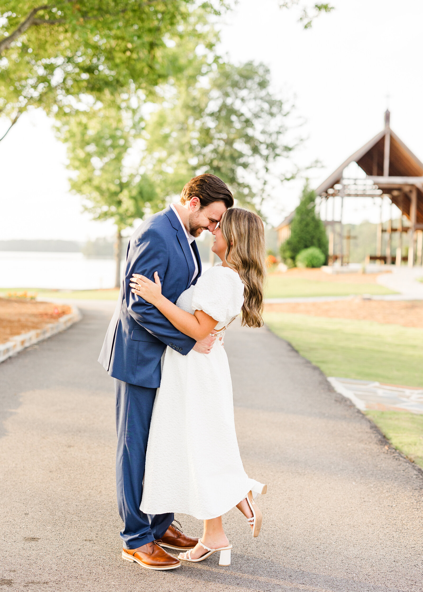 Romantic portrait of Julianna and Josh near a chapel, showcasing timeless love by Abby Bell Photography in Alabama.