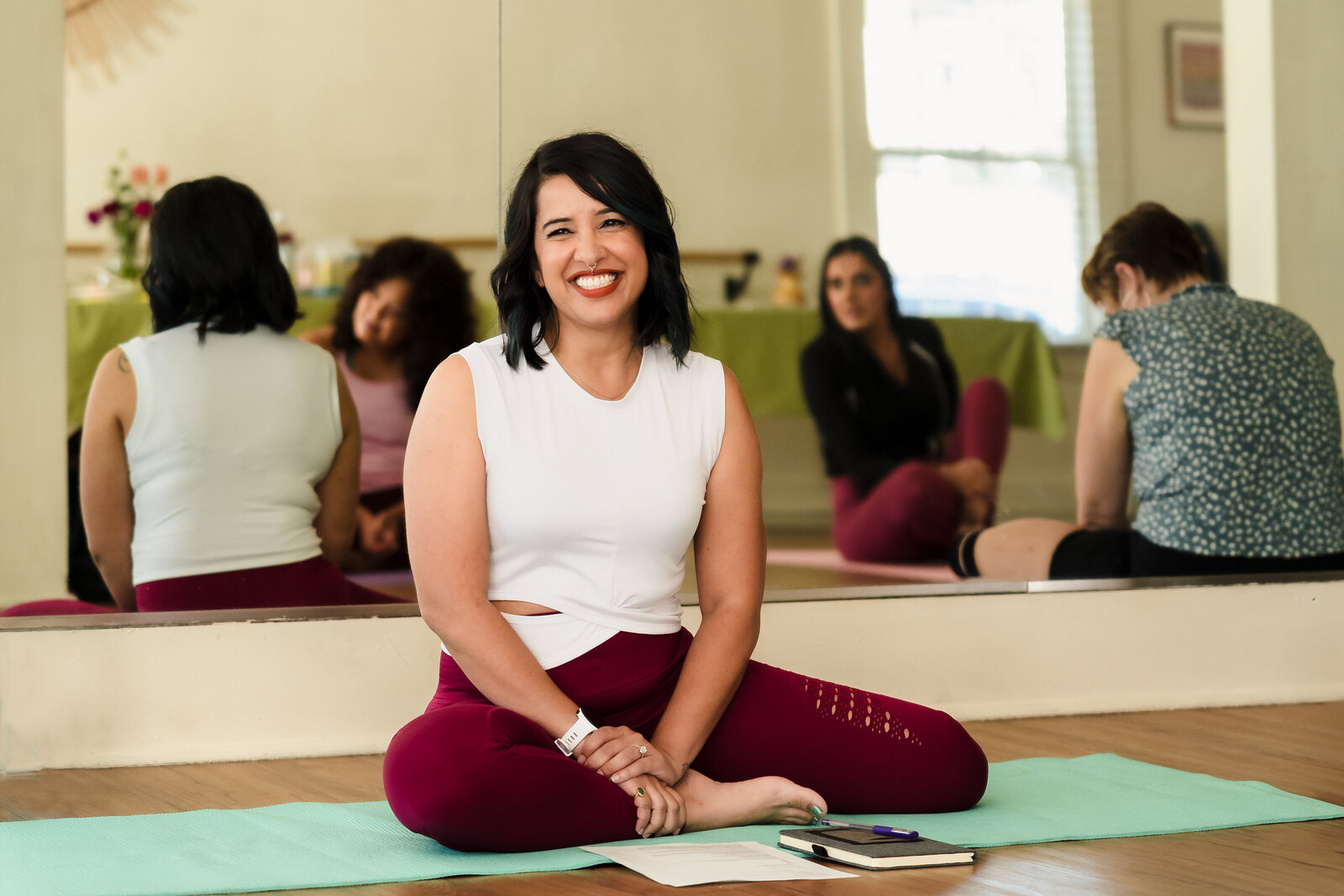 woman in a yoga class smiling
