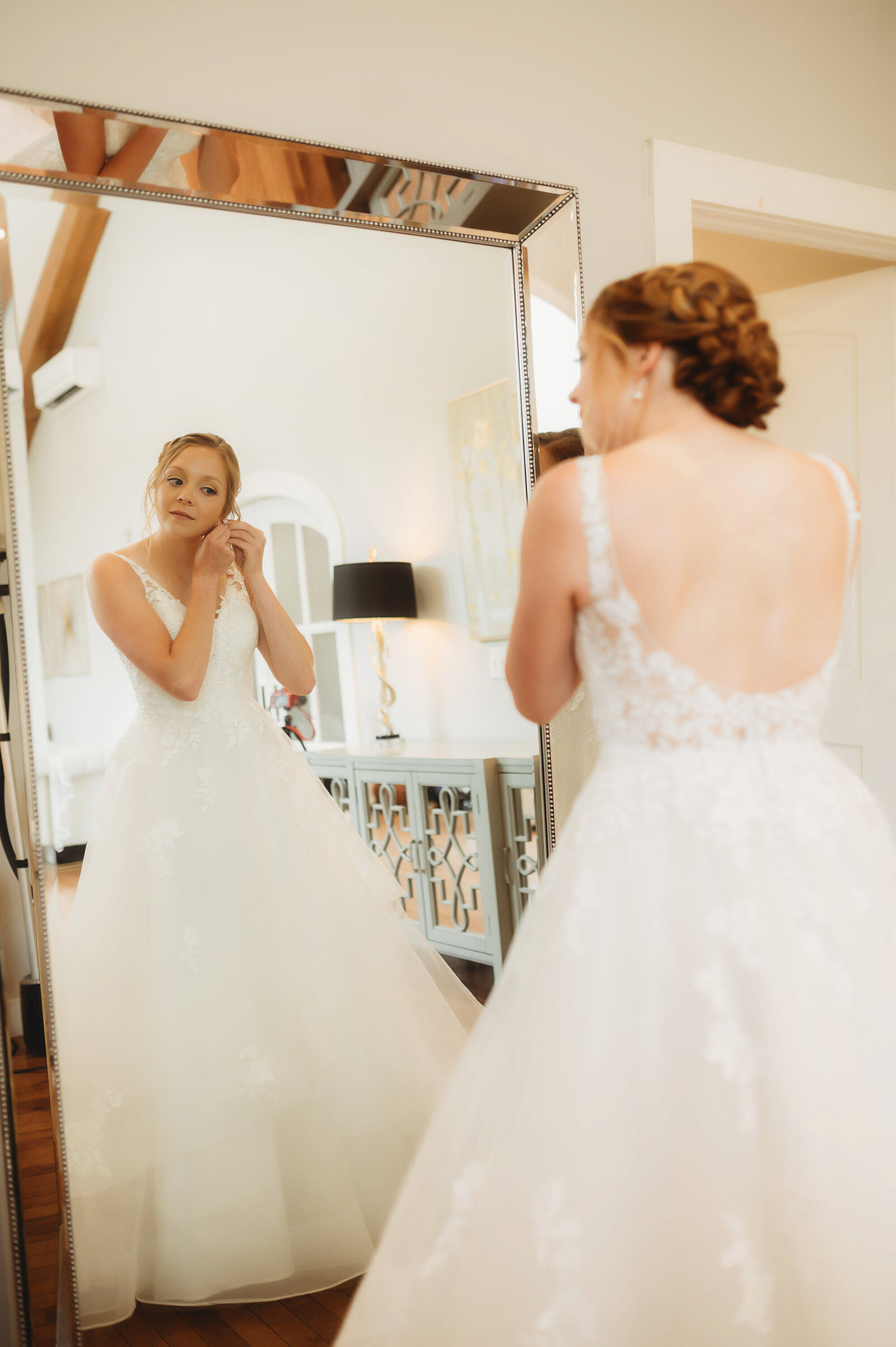 Bride prepares for her wedding day with her mother in the bridal suit at Chestnut Ridge Events in Asheville, NC