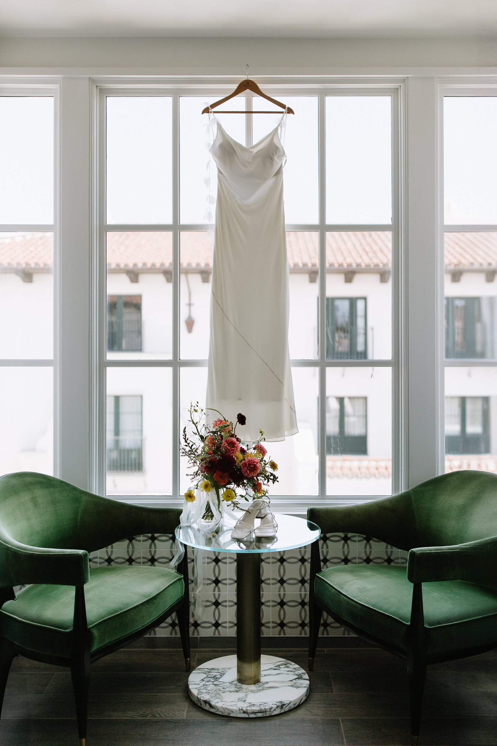 Bride silk gown hanging from window by wedding photographer Northern California, Erica Rochelle