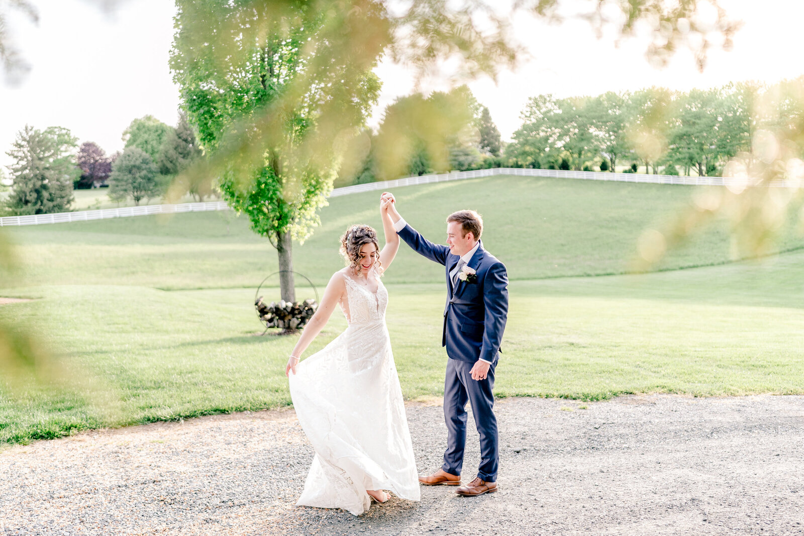 A bride and groom dance together in golden hour light during their wedding at Blue Hill Farm in Northern Virginia