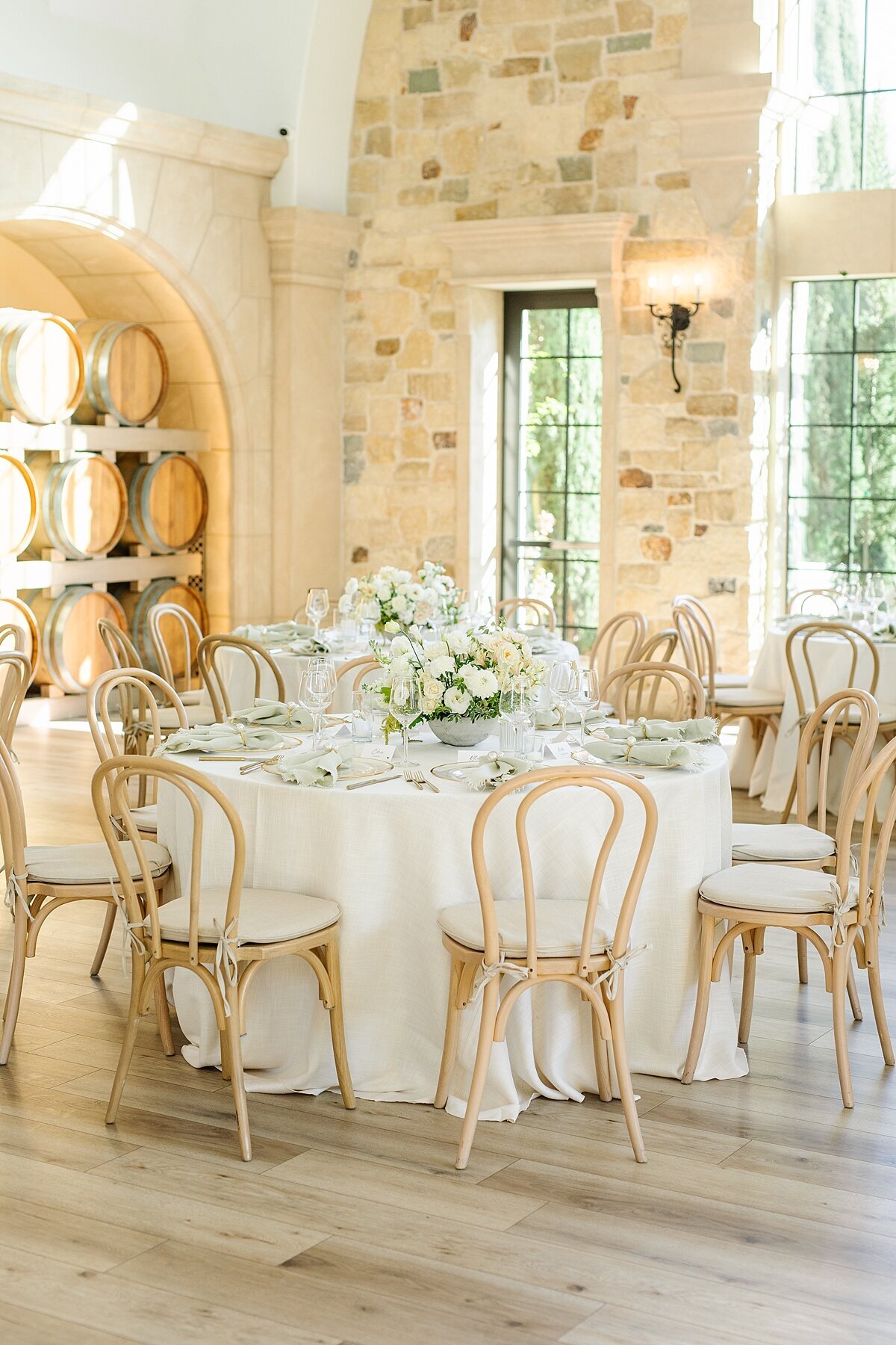 White and green florals on round reception tables at Monserate Winery Weddings in Fallbrook, California.