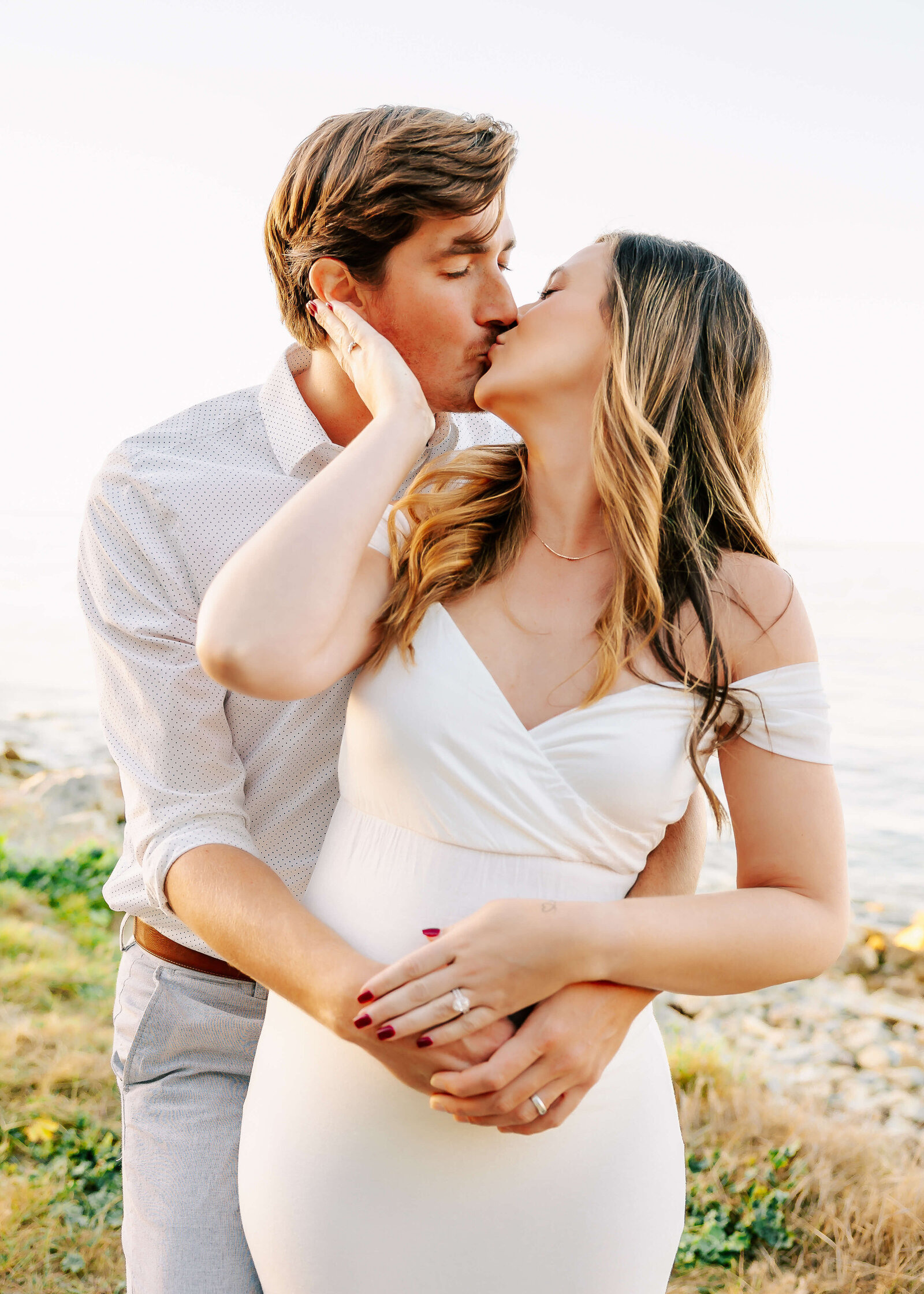 Couple embraced and kissing during Rancho9 Palos Verdes, CA maternity session by Ashley Nicole Photography.