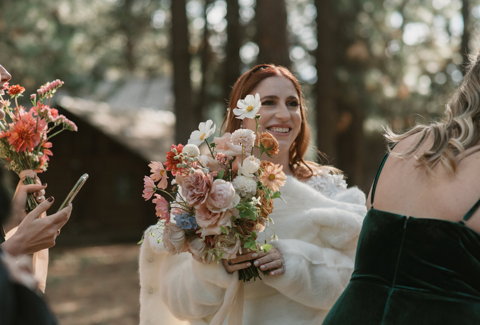 candid photo of bride with bridesmaids holding their bouquets