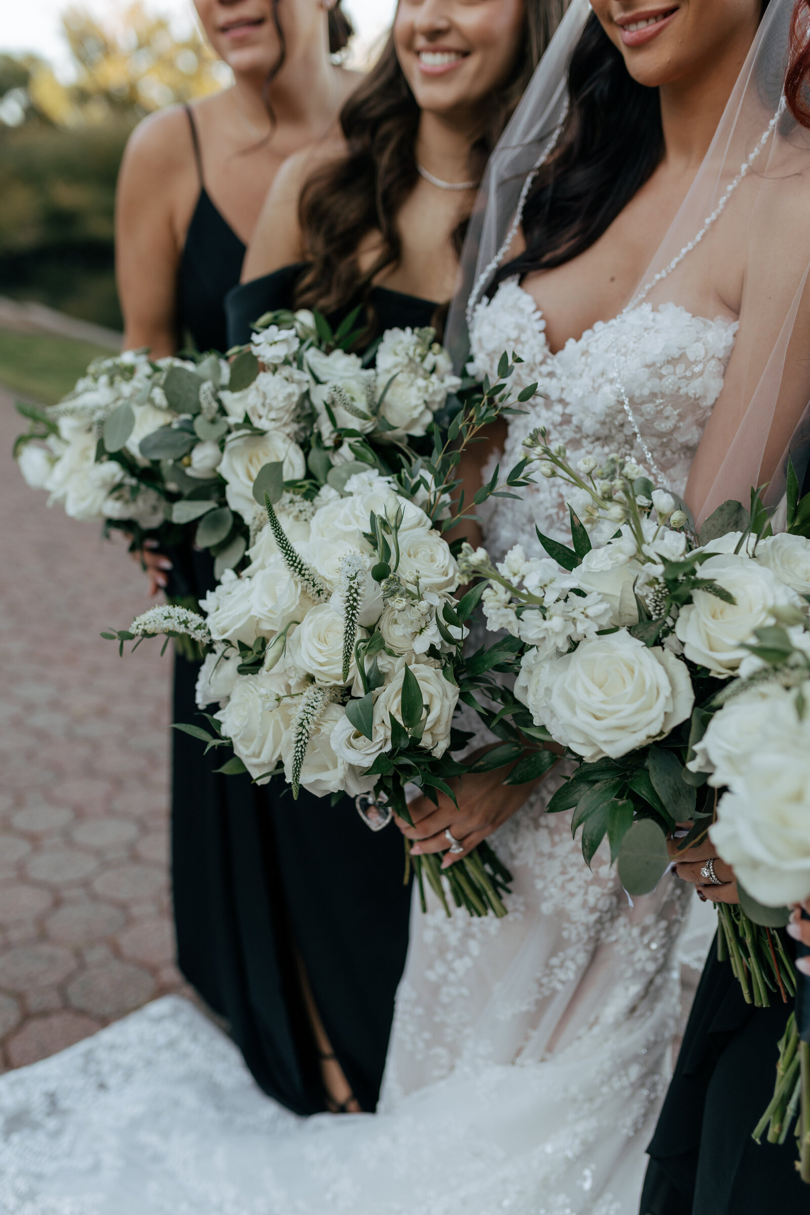 The bride with her bridesmaids dressed in black holding their bouquets | Emma LeeAnn Photography