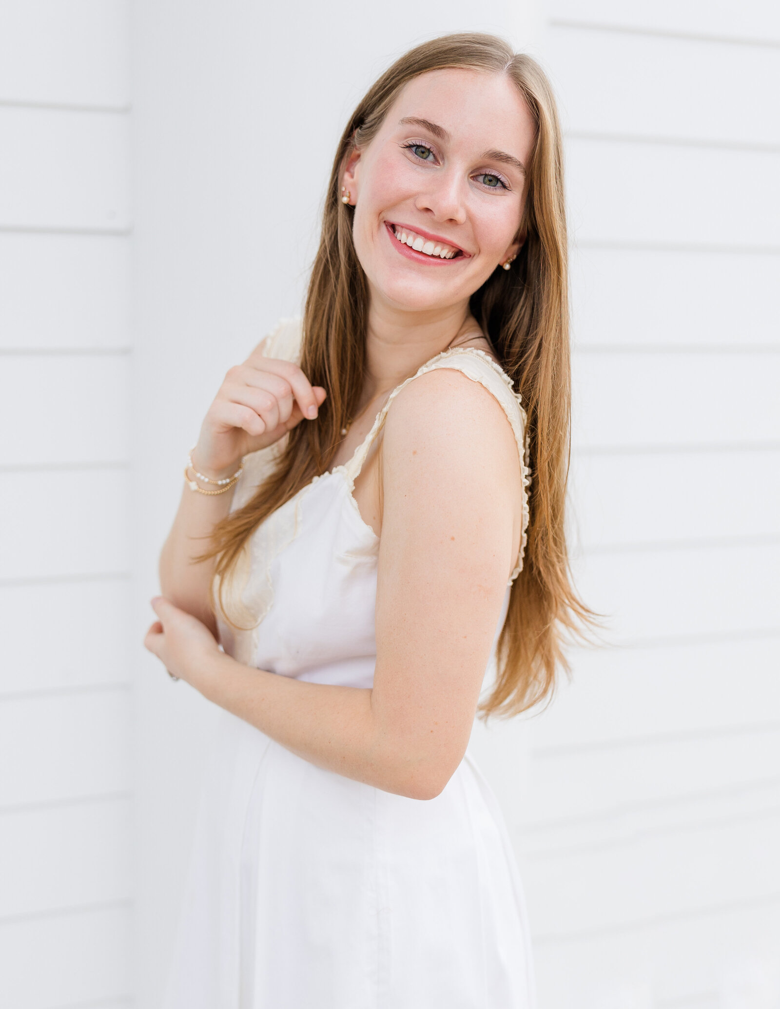 Sophie smiling in a white dress during her senior portrait session, captured by Abby Bell Photography, Fine Art Portrait Photographer based in Alabama.