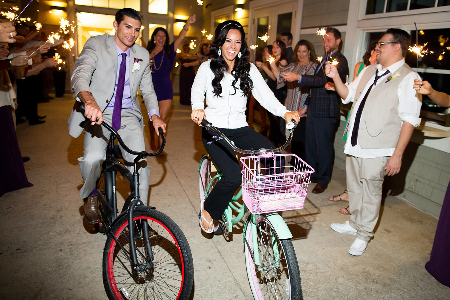 bride and groom leaving party on their bikes on coronado community center