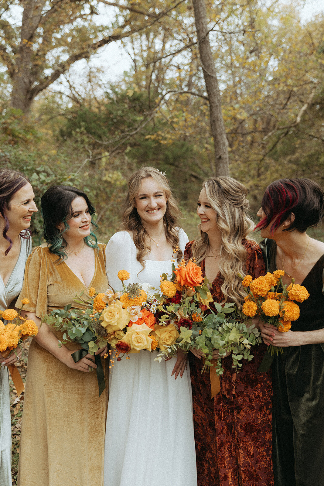 Bold bridesmaid bouquets in bright, contrasting hues, designed to complement a colorful summer wedding in Fort Worth.