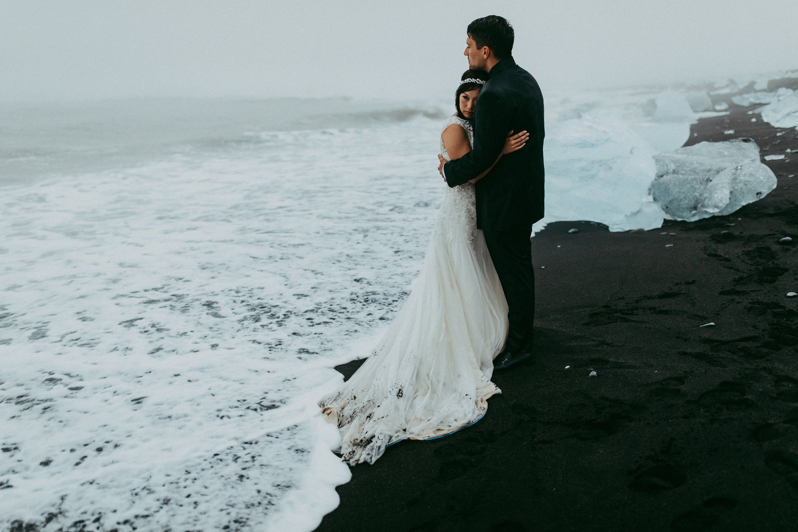 couple eloping on black sand beach in iceland