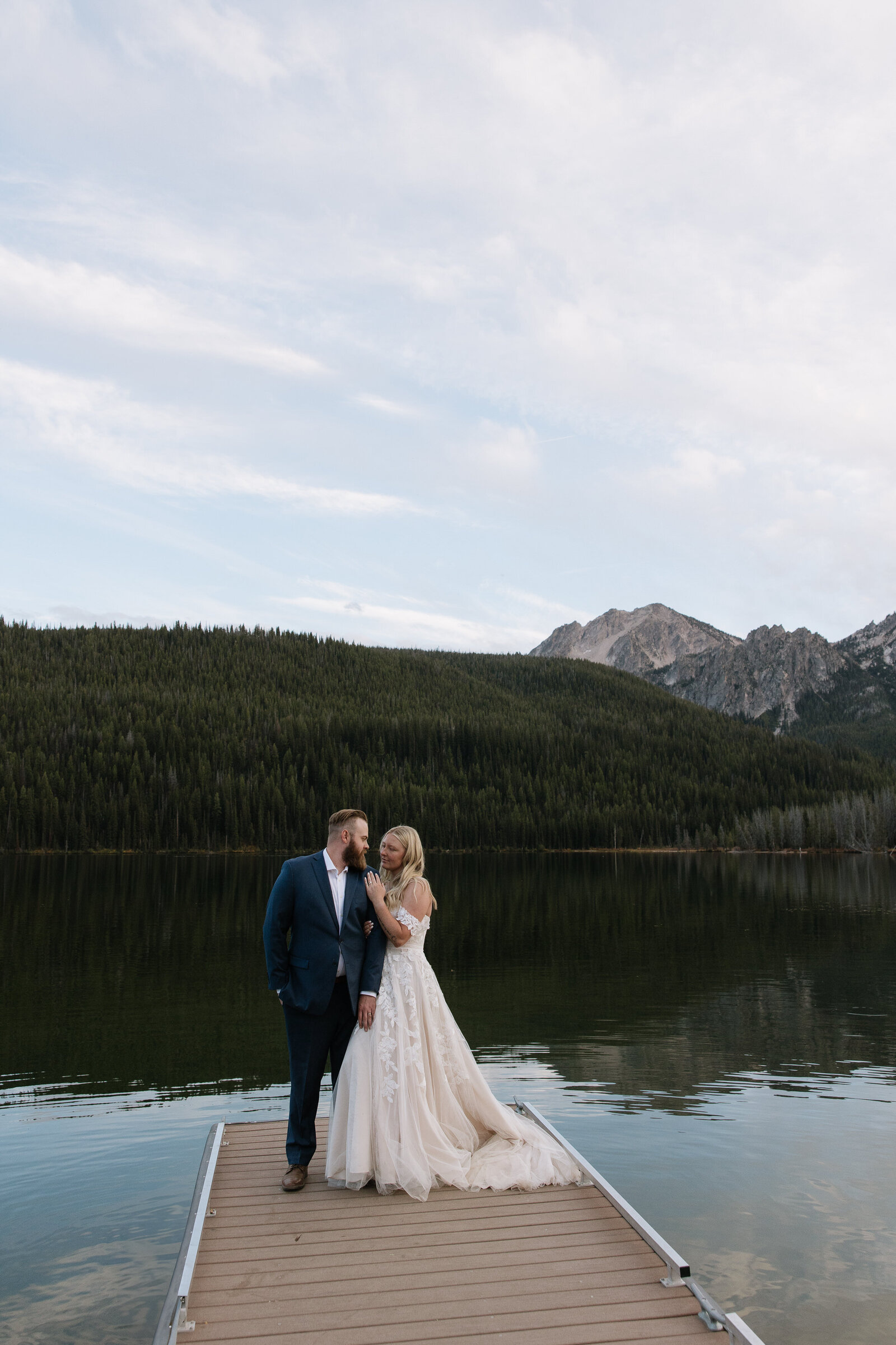 Couple embracing at Stanley Lake after their intimate elopement ceremony
