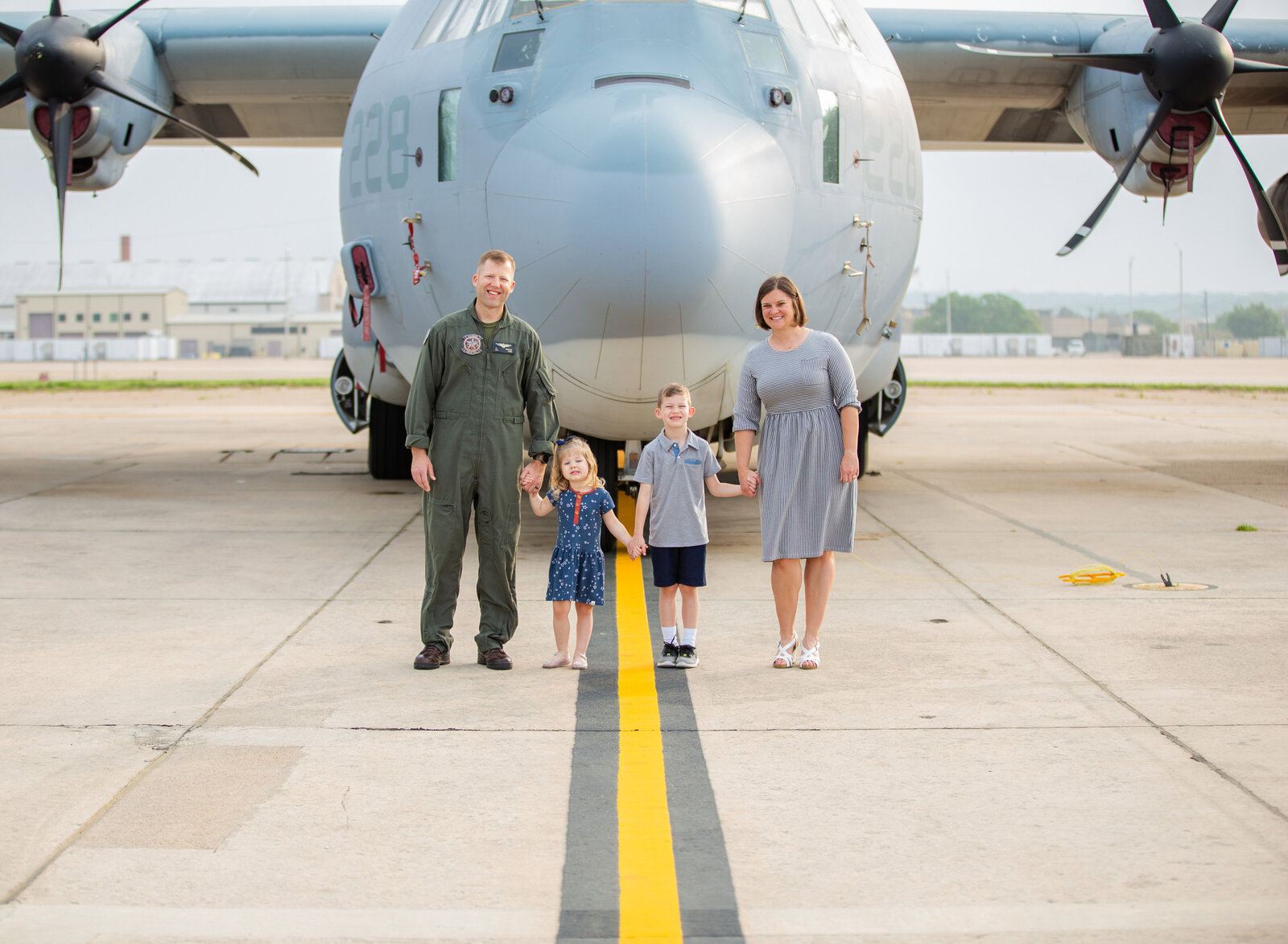 military family in front of plan