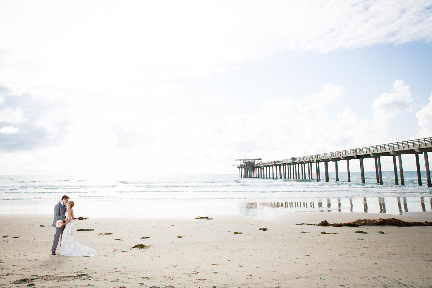 couple walking on the sand kissing