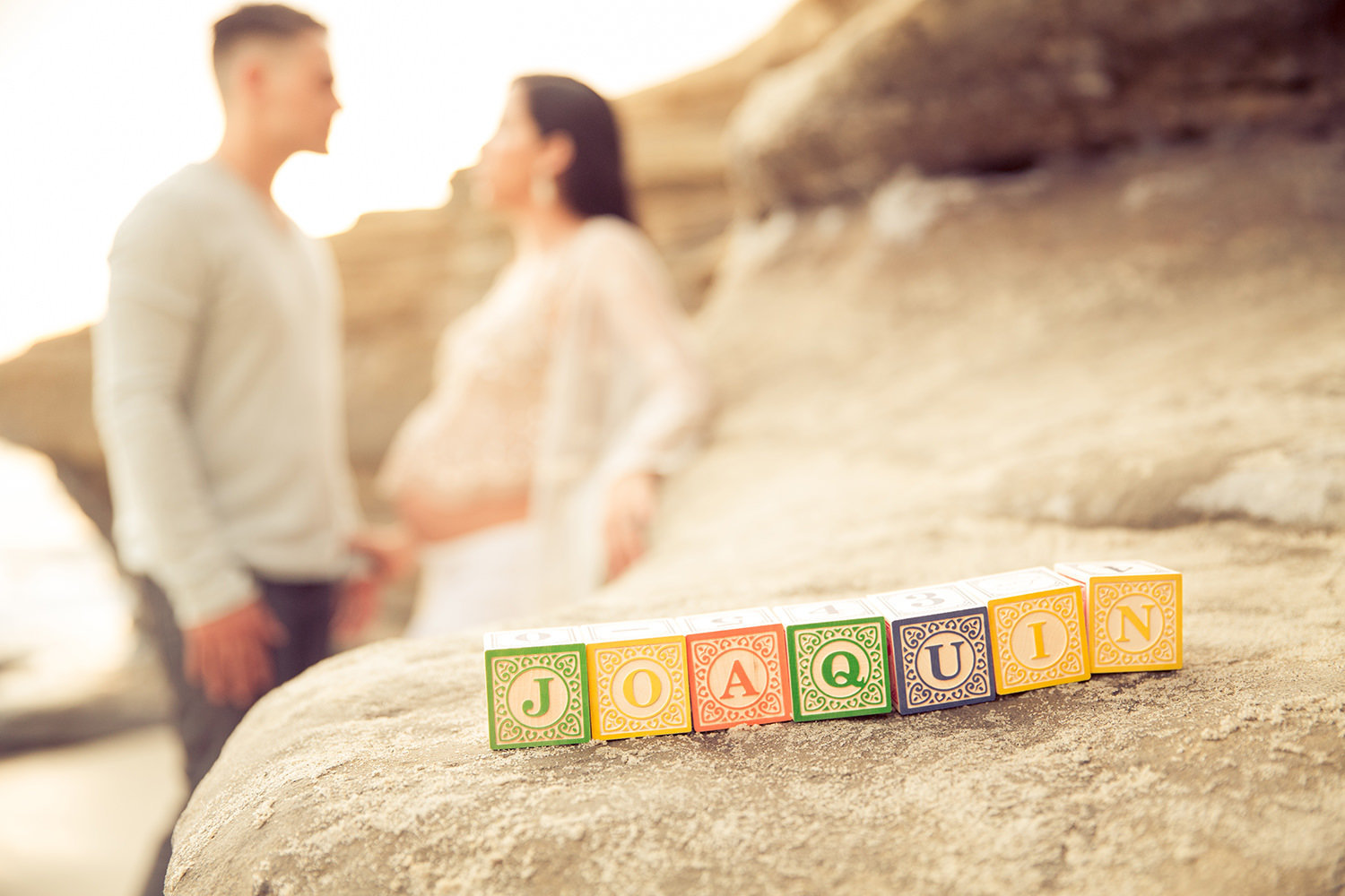 Baby blocks on a cliff on the beach in La Jolla for Maternity Session.
