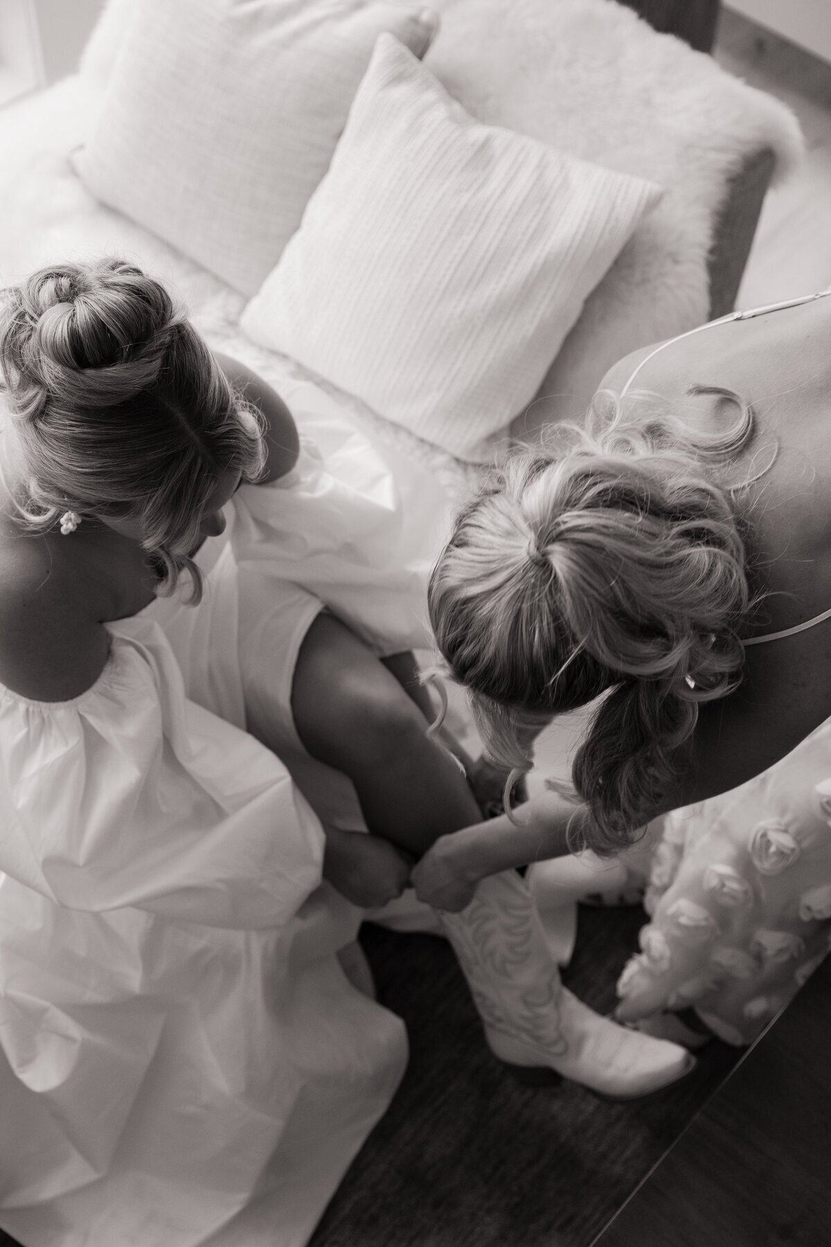 Bride getting help with shoes taken by destination wedding photographers Erica Rochelle Photography