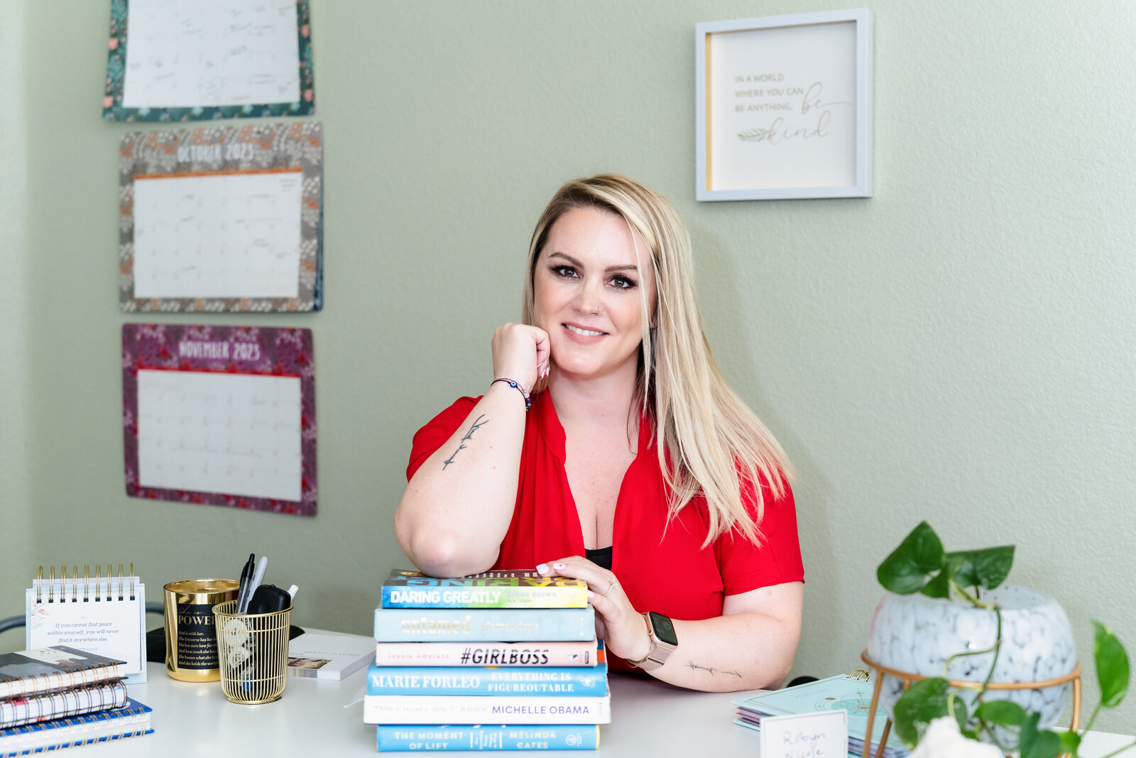 coach posing with her favorite books in her desk