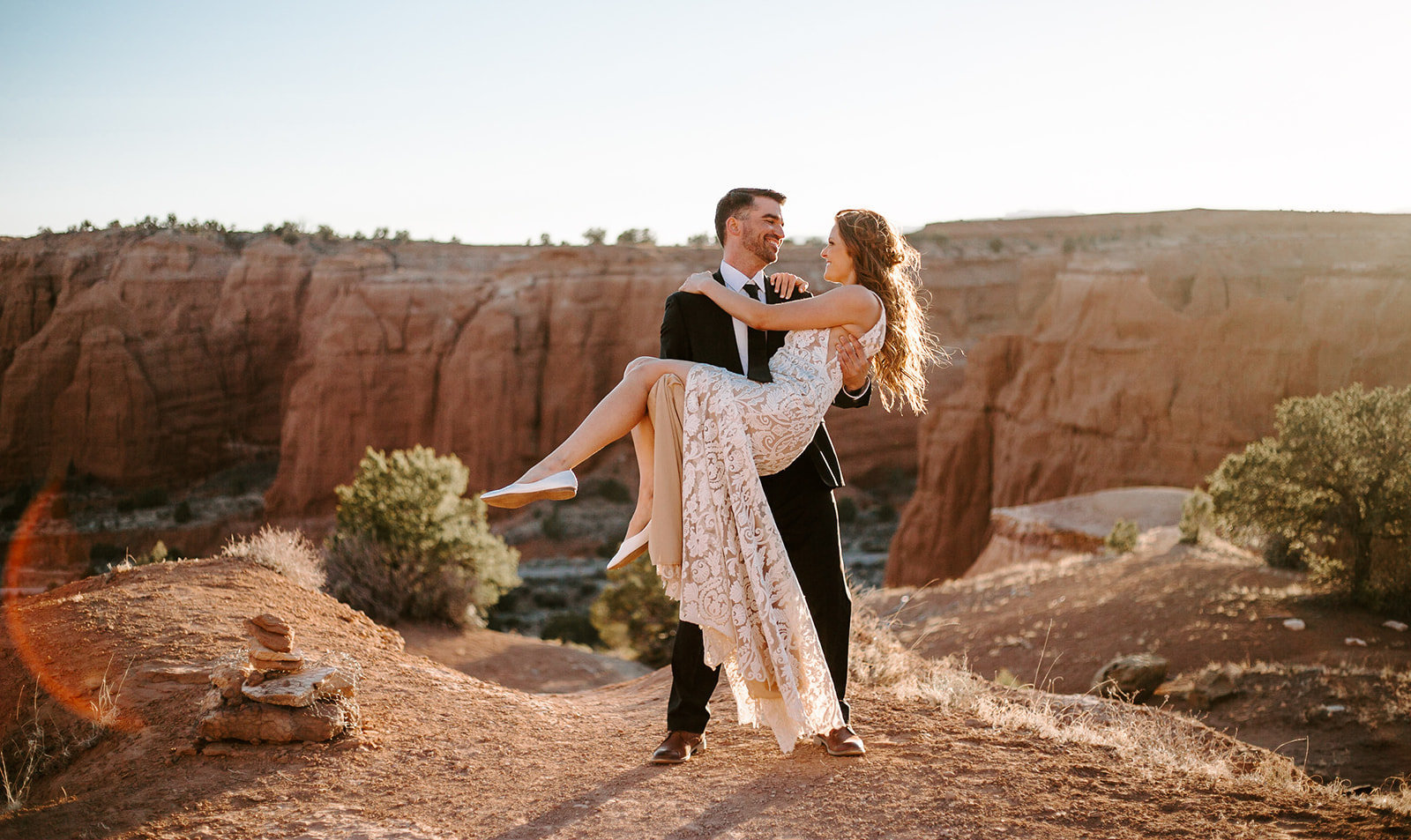 Groom holding his bride next to the grand canyon during their Arizona elopement