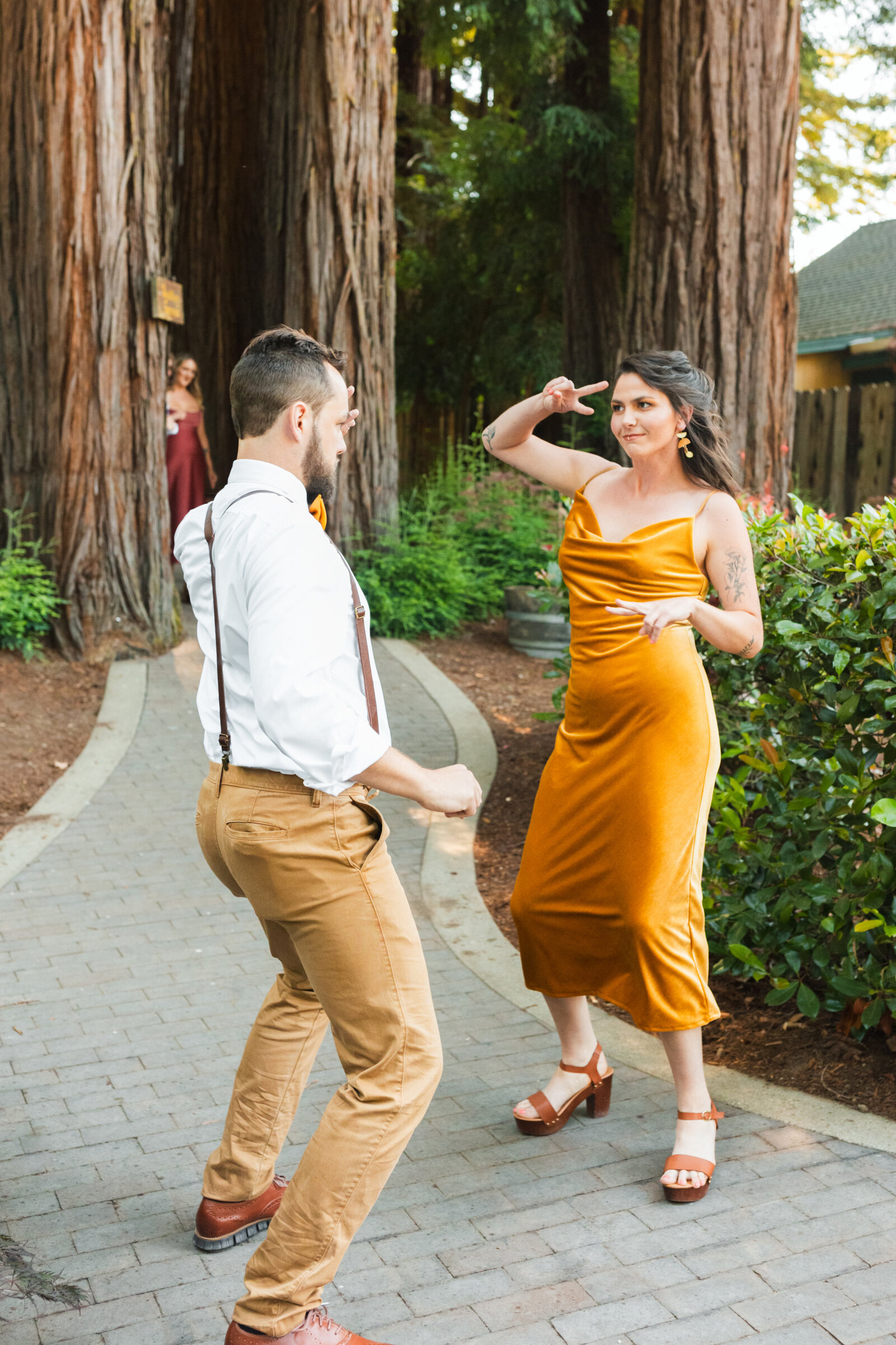 Bridal party at a colorful wedding ceremony in Santa Cruz, California in the redwood trees.