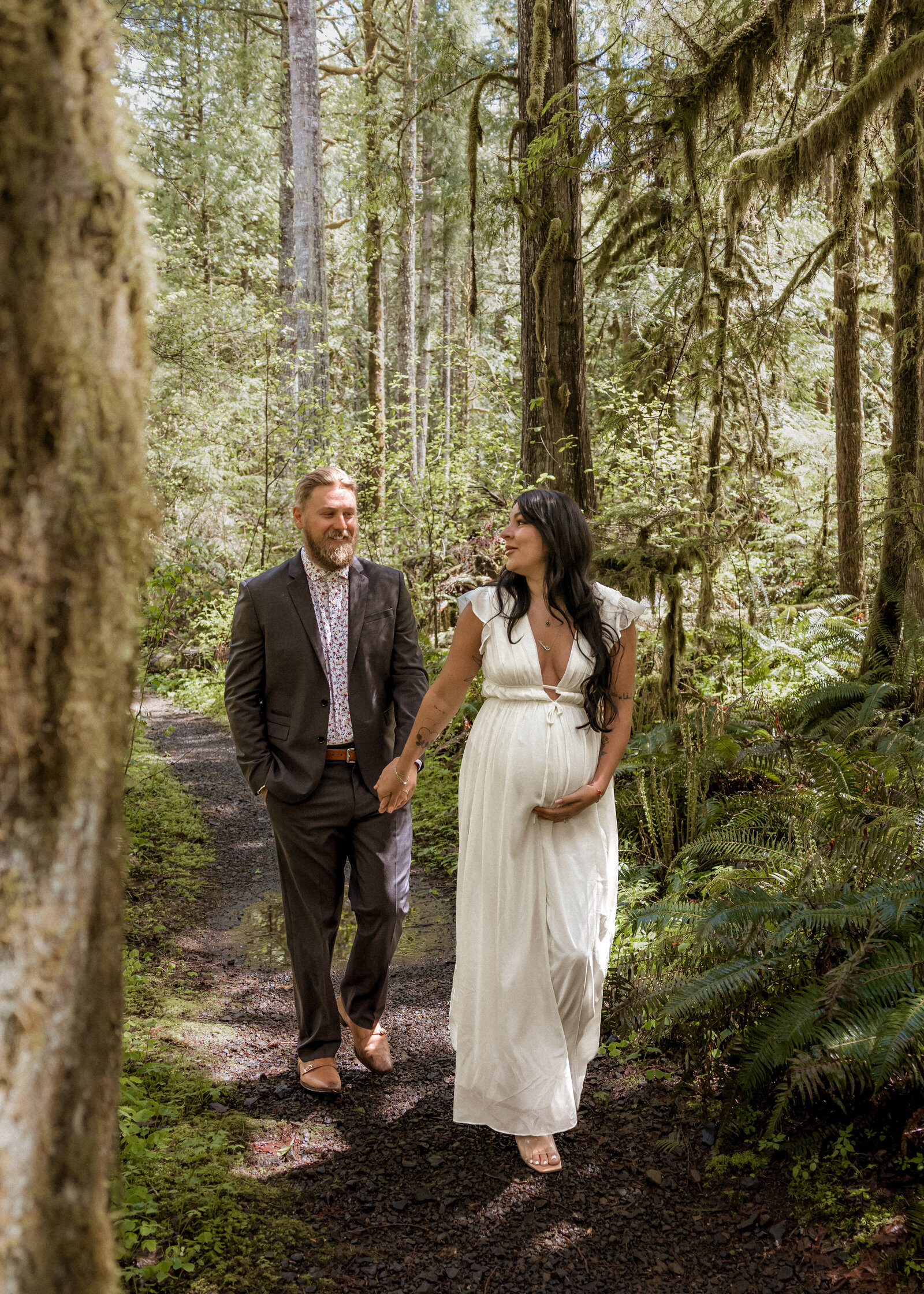 Couple walking through the Mount Hood Forest for a Maternity Photoshoot
