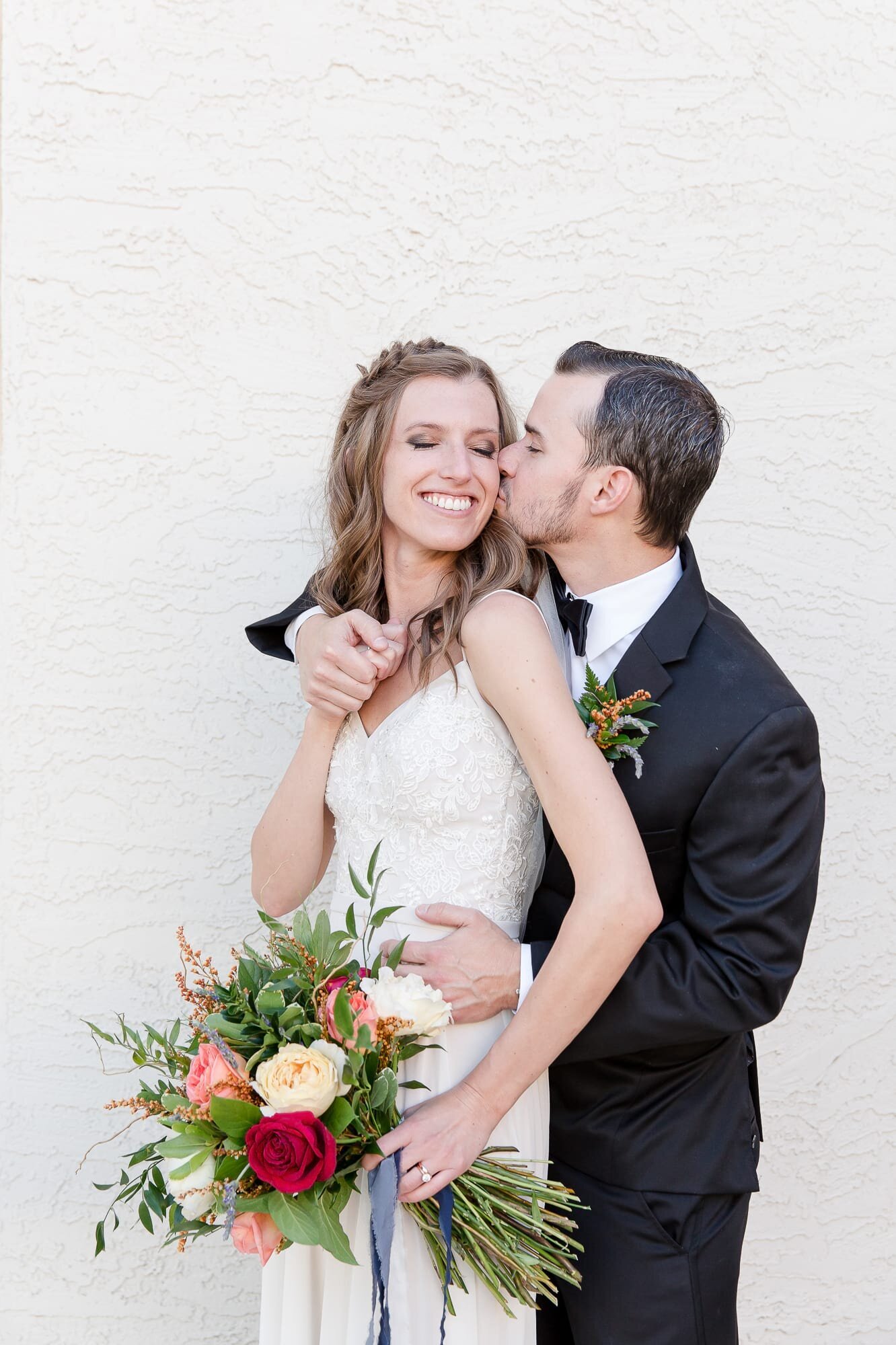 groom-kissing-brides-cheek