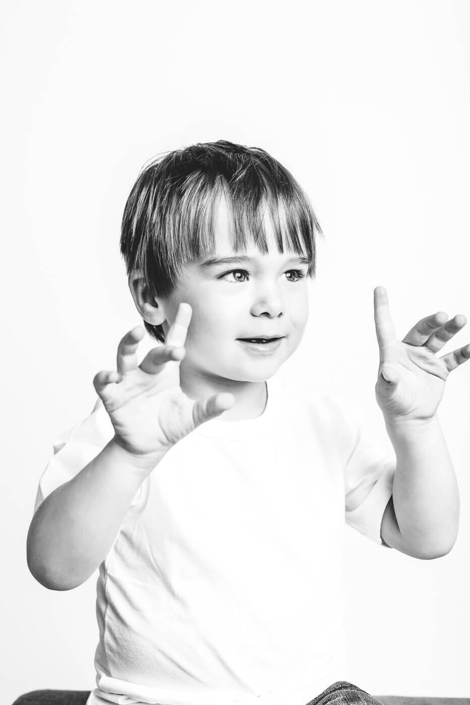 Boy doing spooky hands for Tampa photographer