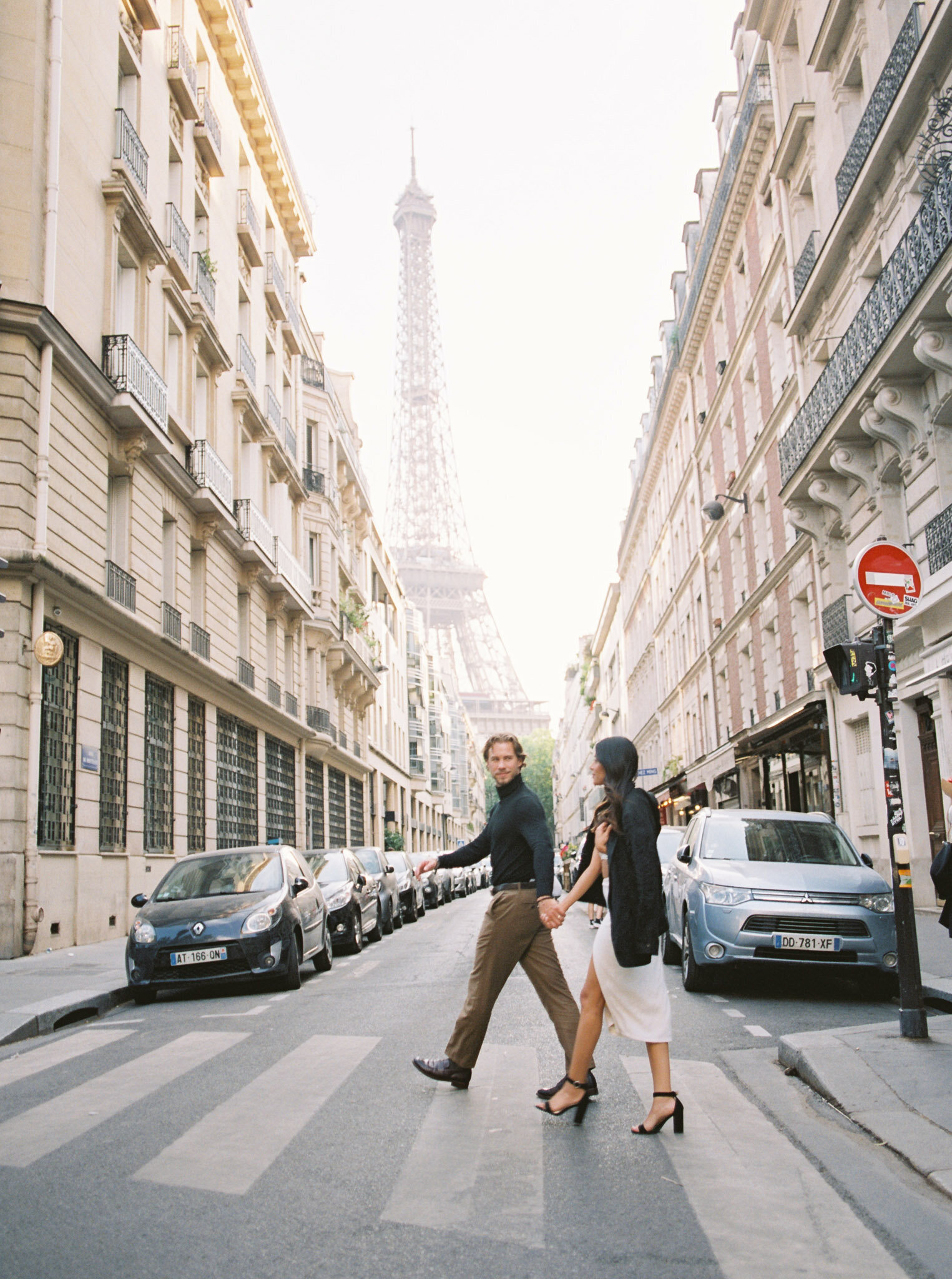 Bride and groom crossing a street in Paris