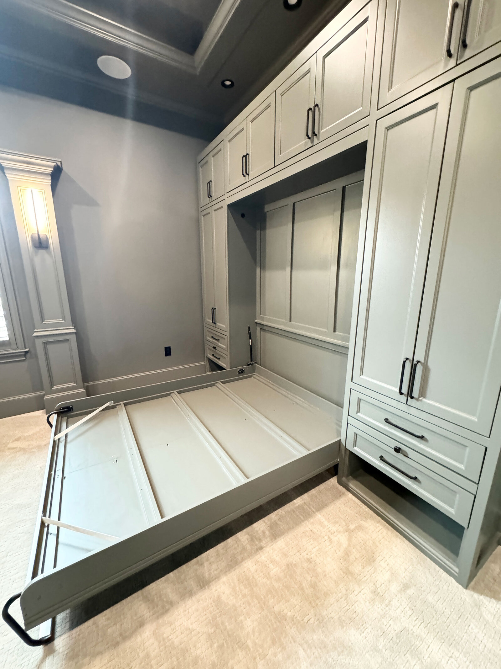 Full-service renovation design for a bedroom with green furniture, creating a fresh and inviting space with modern design elements and thoughtful color coordination.