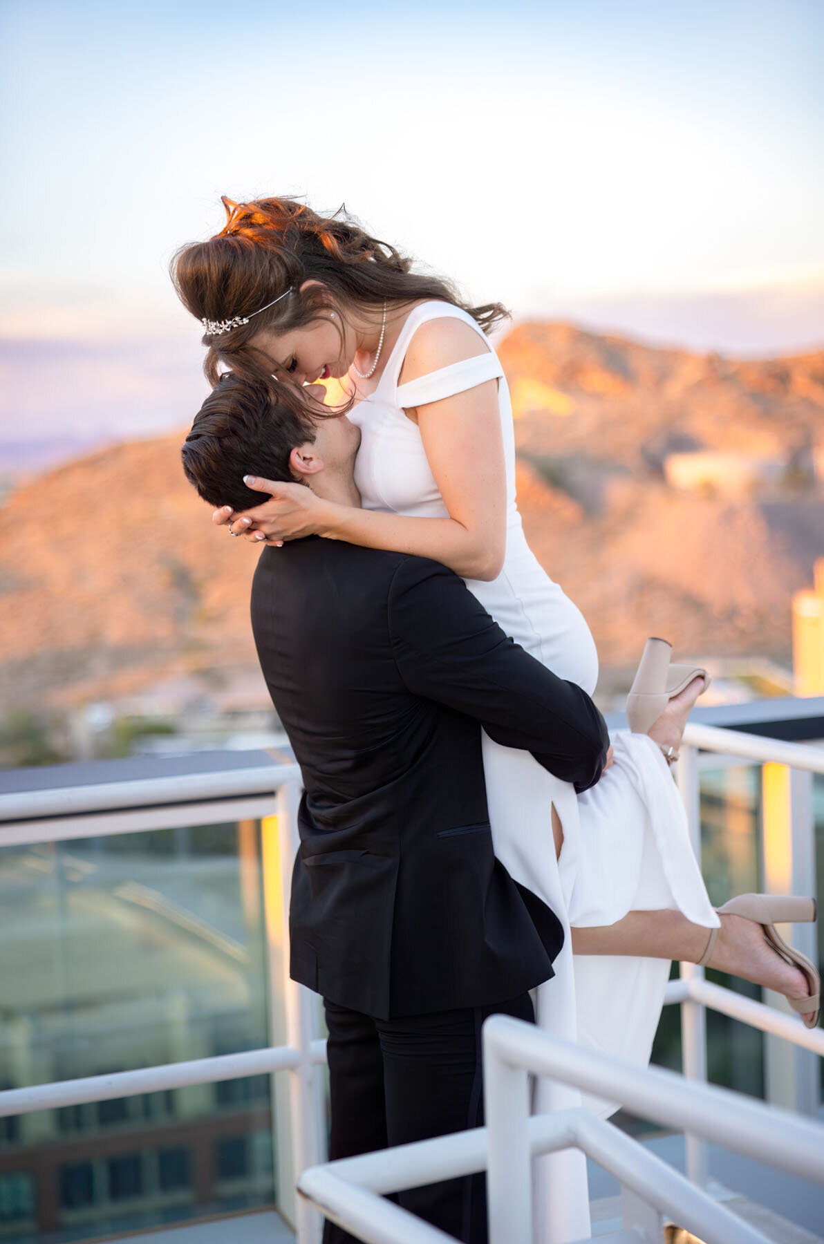 Bride lifted up by her husband for photo in Scottrsdale Arizona.