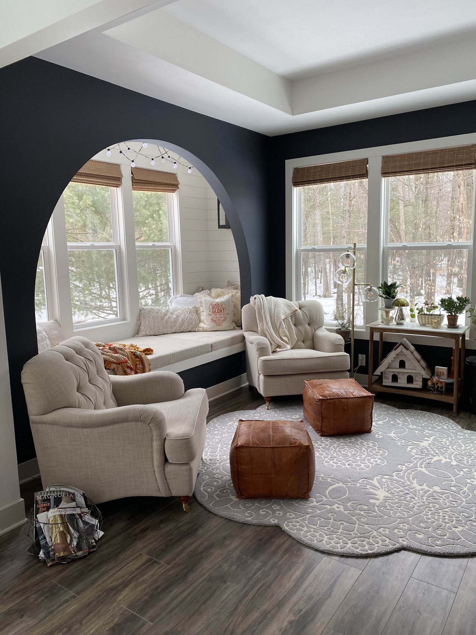 arched opening in a sunroom that has a bench area with pillows