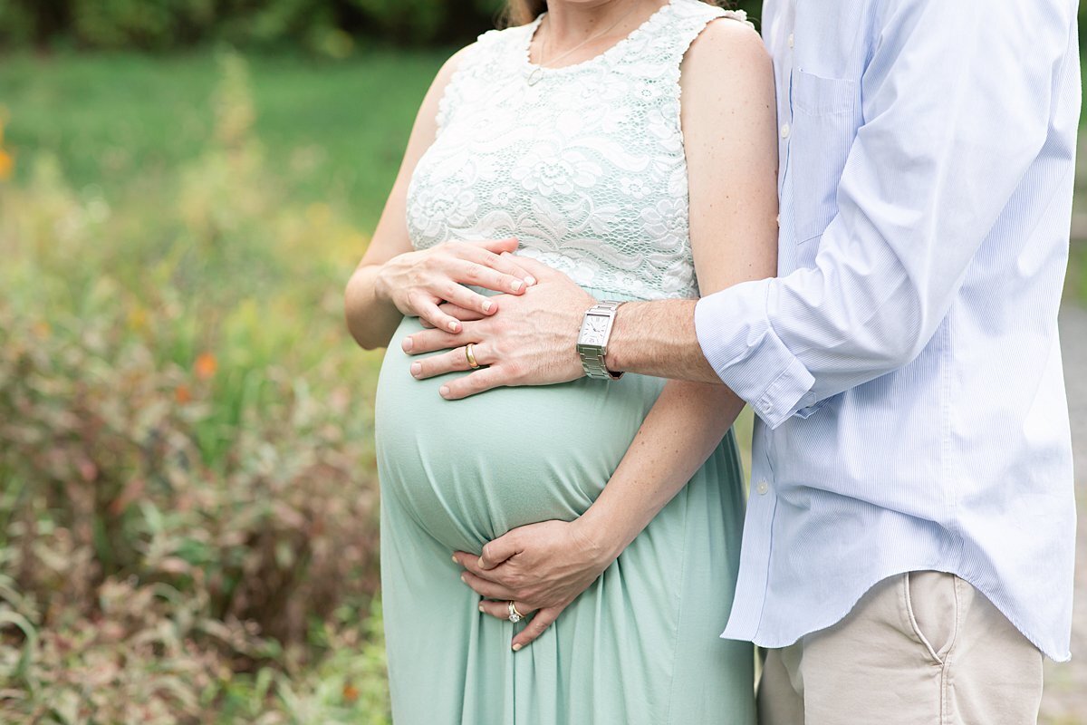 Pregnant couple with hands on baby belly byMaryland Maternity Photographer : Rebecca Leigh Photography