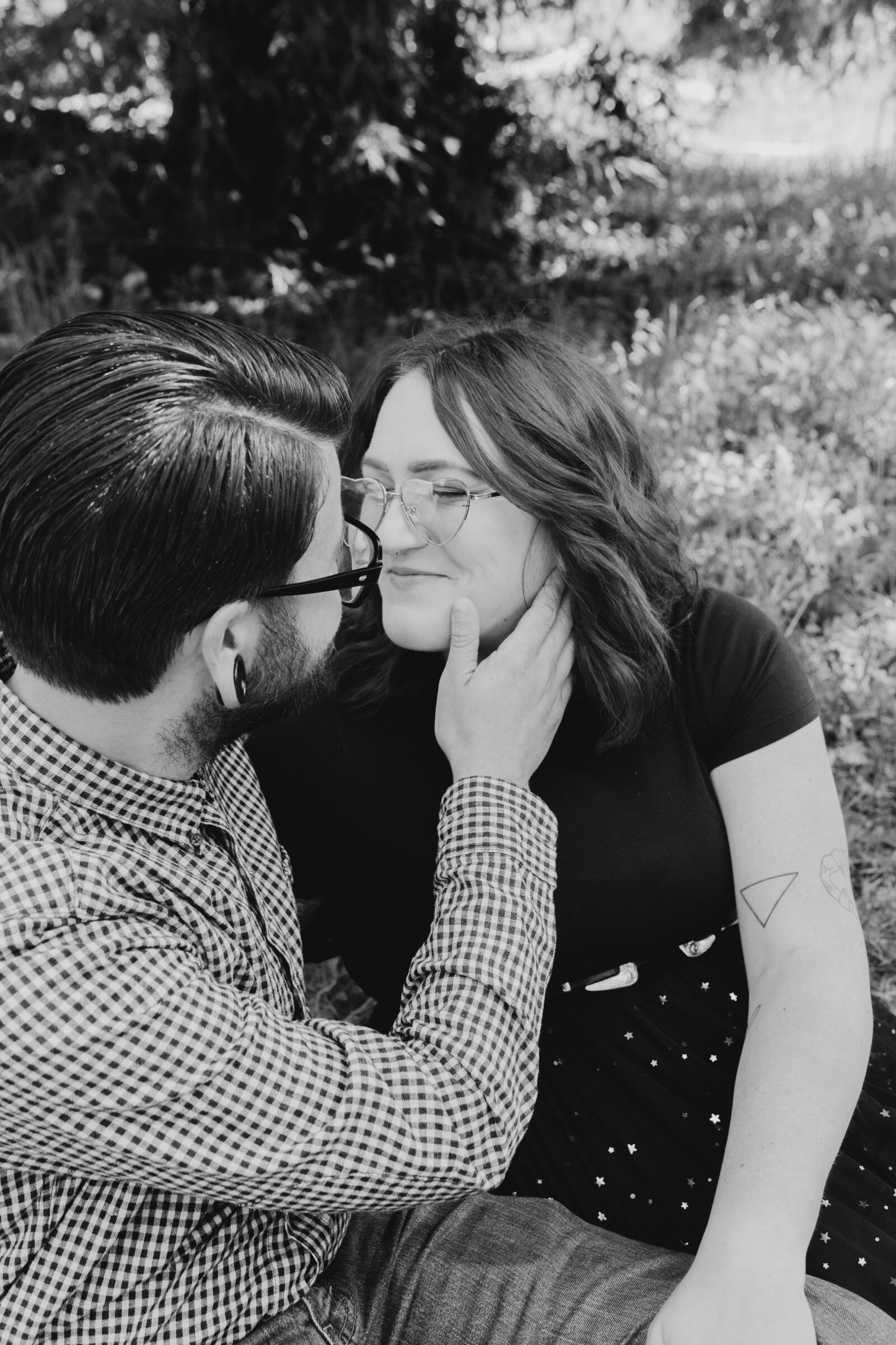 An tattooed engaged couple poses for photos in a redwood forest in Santa Cruz, Ca.