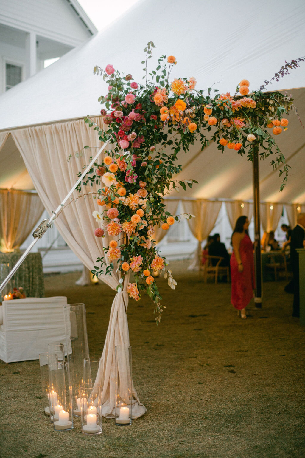 Florals and candles at tented Wedding reception at Lyceum Lawn